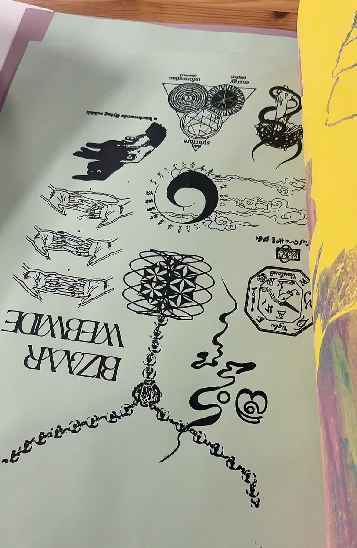 Black and white drawings and symbols on a pale green sheet of paper.