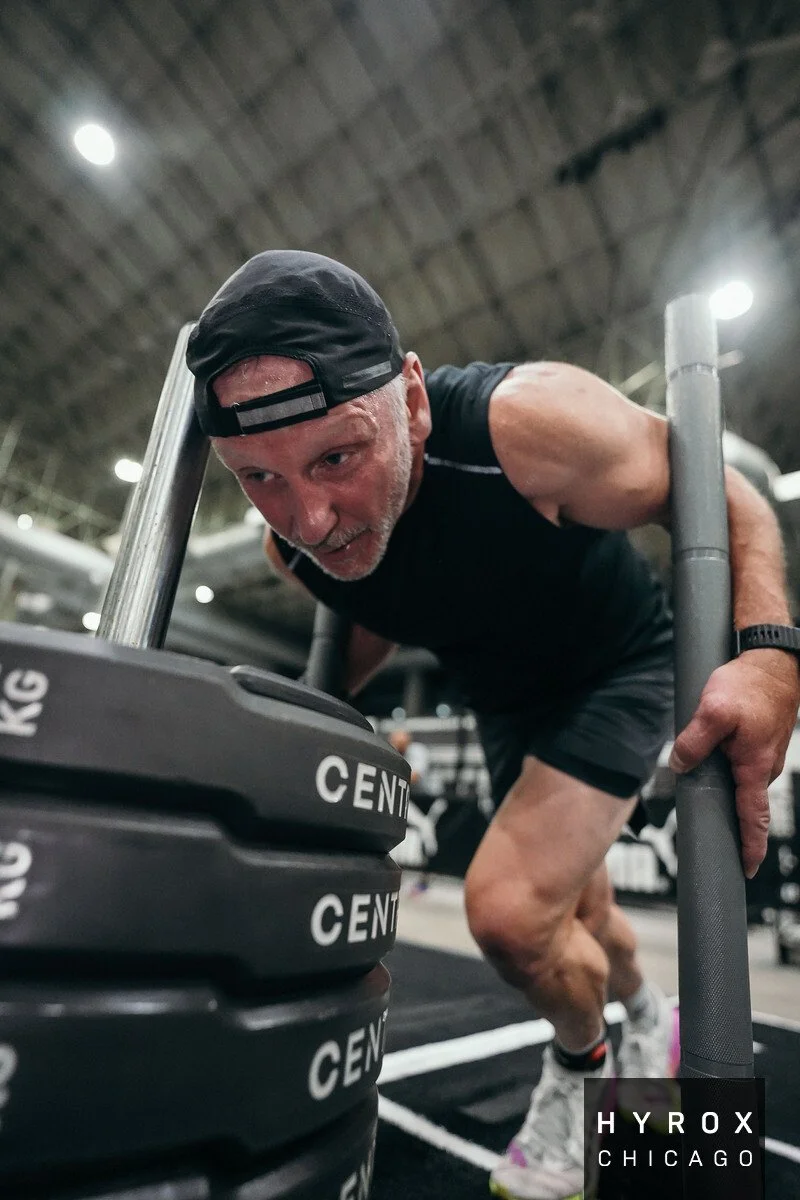 Brian Stokes performing a HYROX sled push during HYROX World Champsionships.