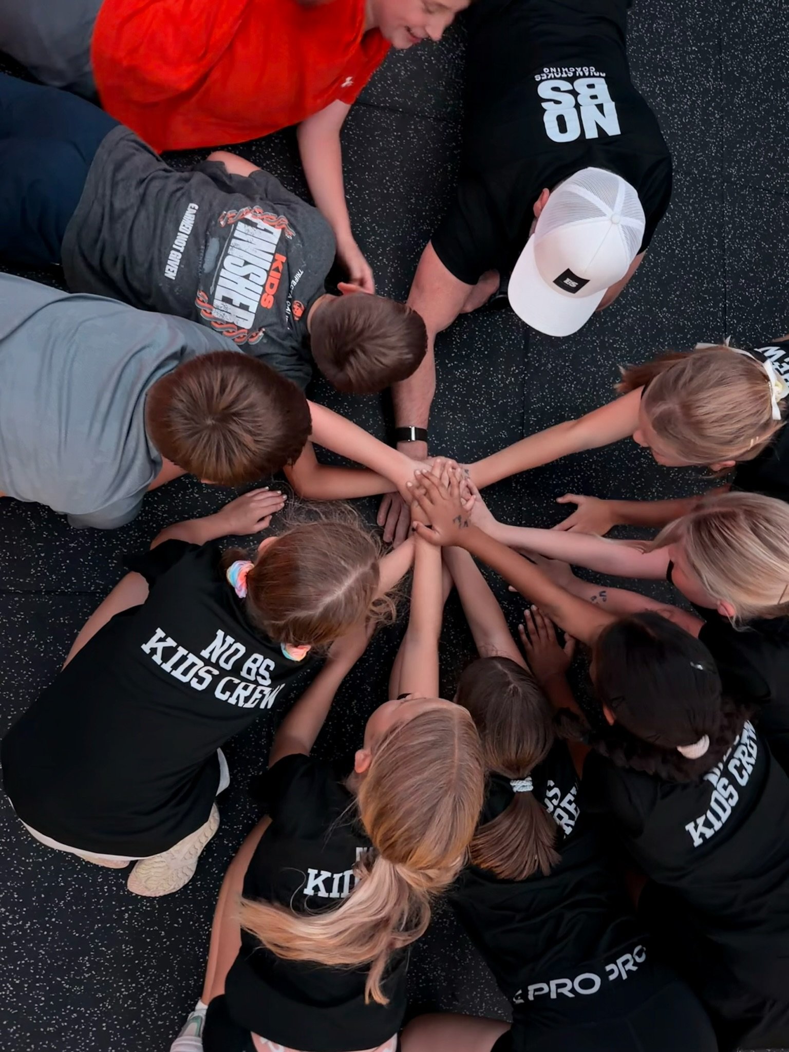 NO BS Kids Crew children working together during a team fitness session.