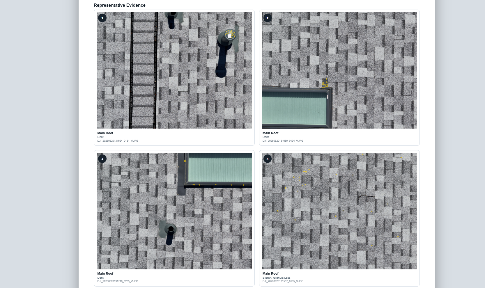 Aerial view of a gray tiled roof with a vent pipe, a skylight, and scattered yellow markers indicating damage or points of interest.