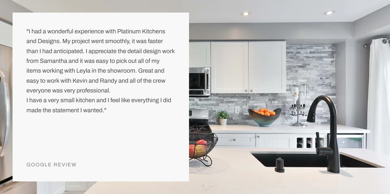 Modern white kitchen with gray stone backsplash, island sink, black faucet, and Google review testimonial overlay
