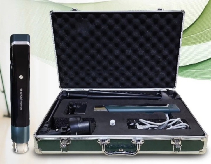A black and green portable laser hair removal device set in a case with tools and attachments, and a standalone laser pen device outside the case.
