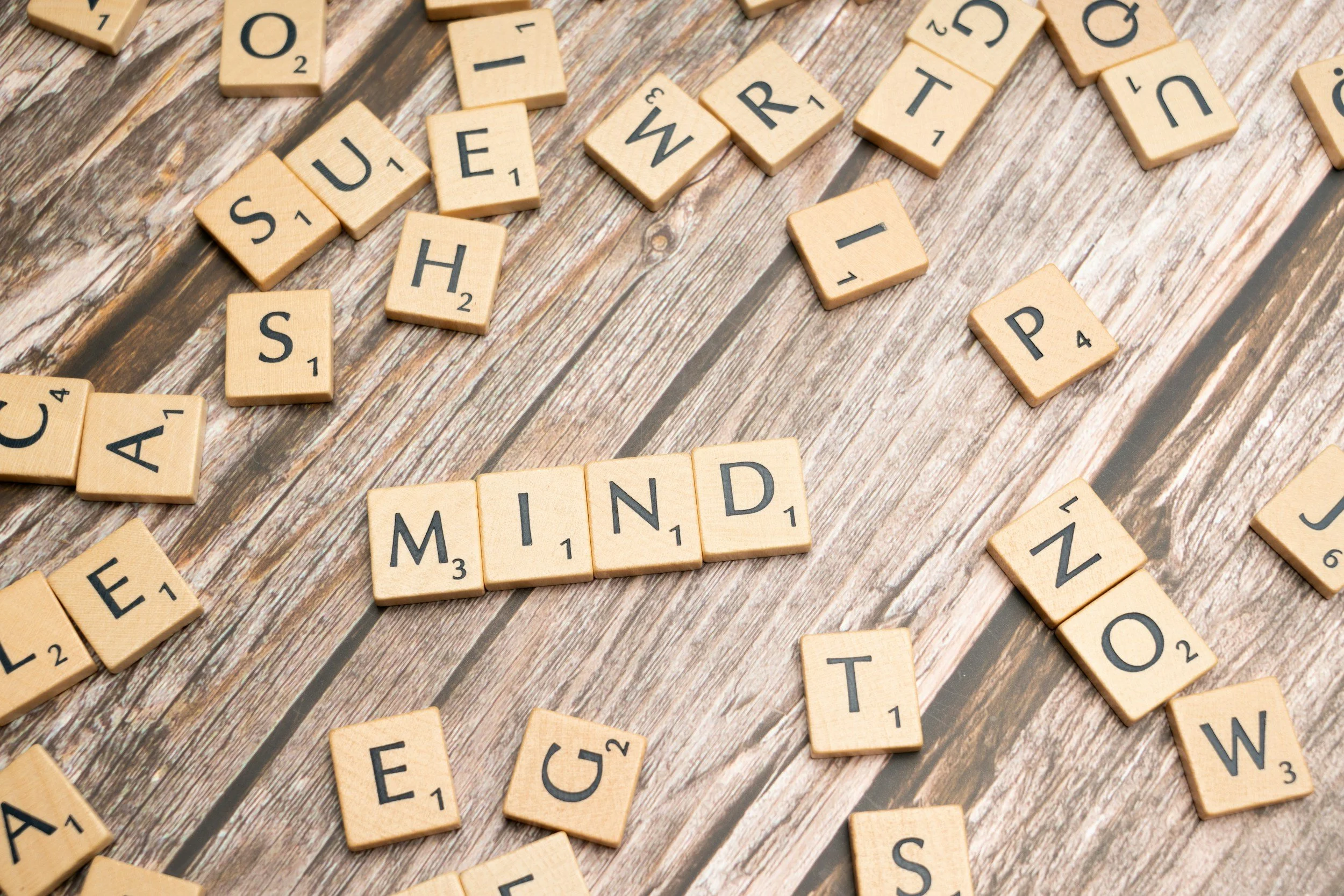 picture of letter tiles spelling the word mind above a picture of therapy representing change