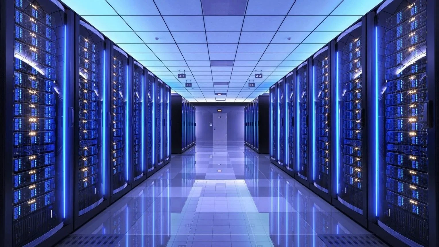Blue-lit server racks lining a reflective aisle in a modern data center