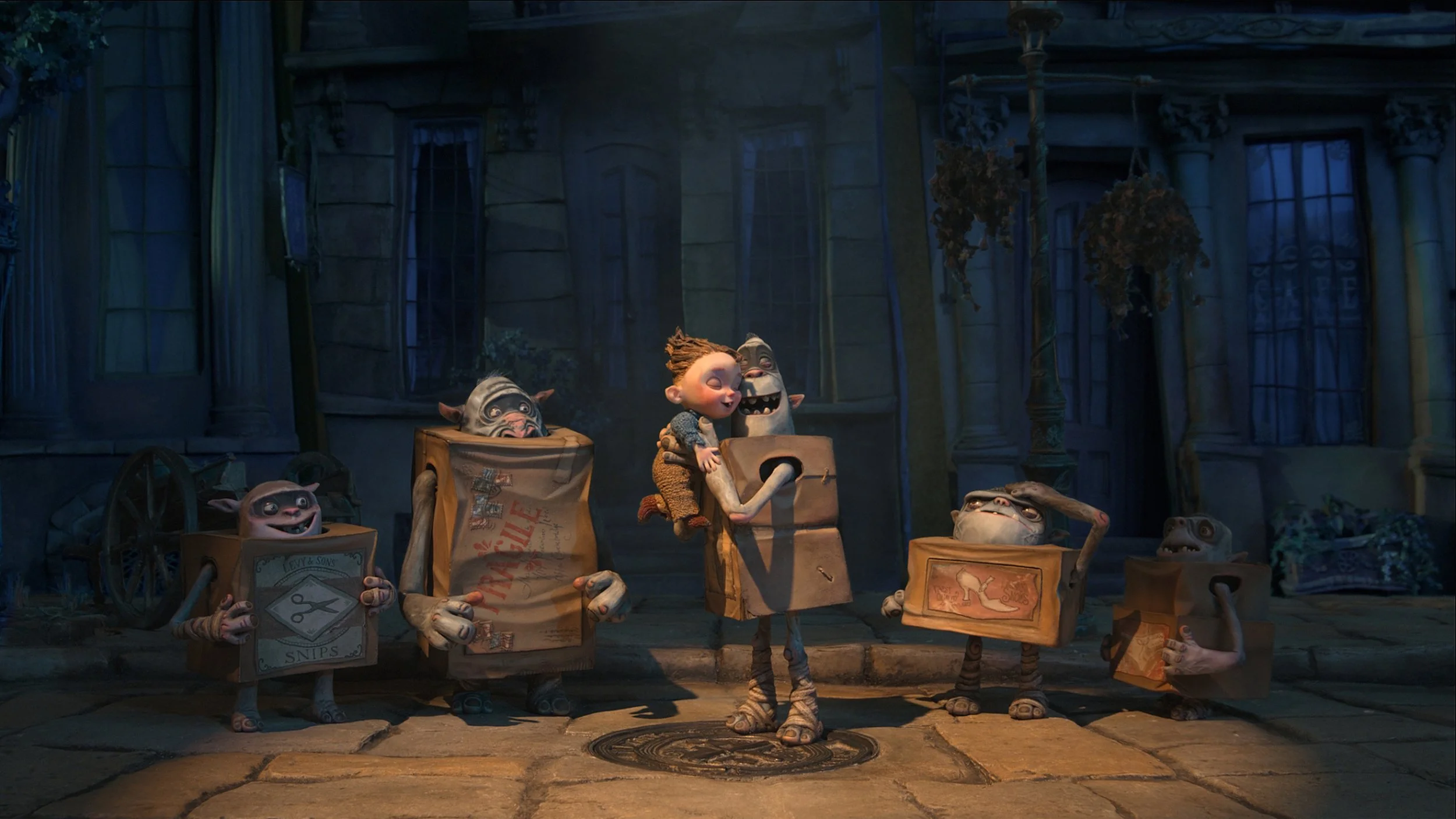 Animated scene of small creatures with big eyes and wide smiles, holding boxes with designs of scissors and high heels, standing on a sidewalk in front of an old house with boarded windows and overgrown trees, during nighttime.