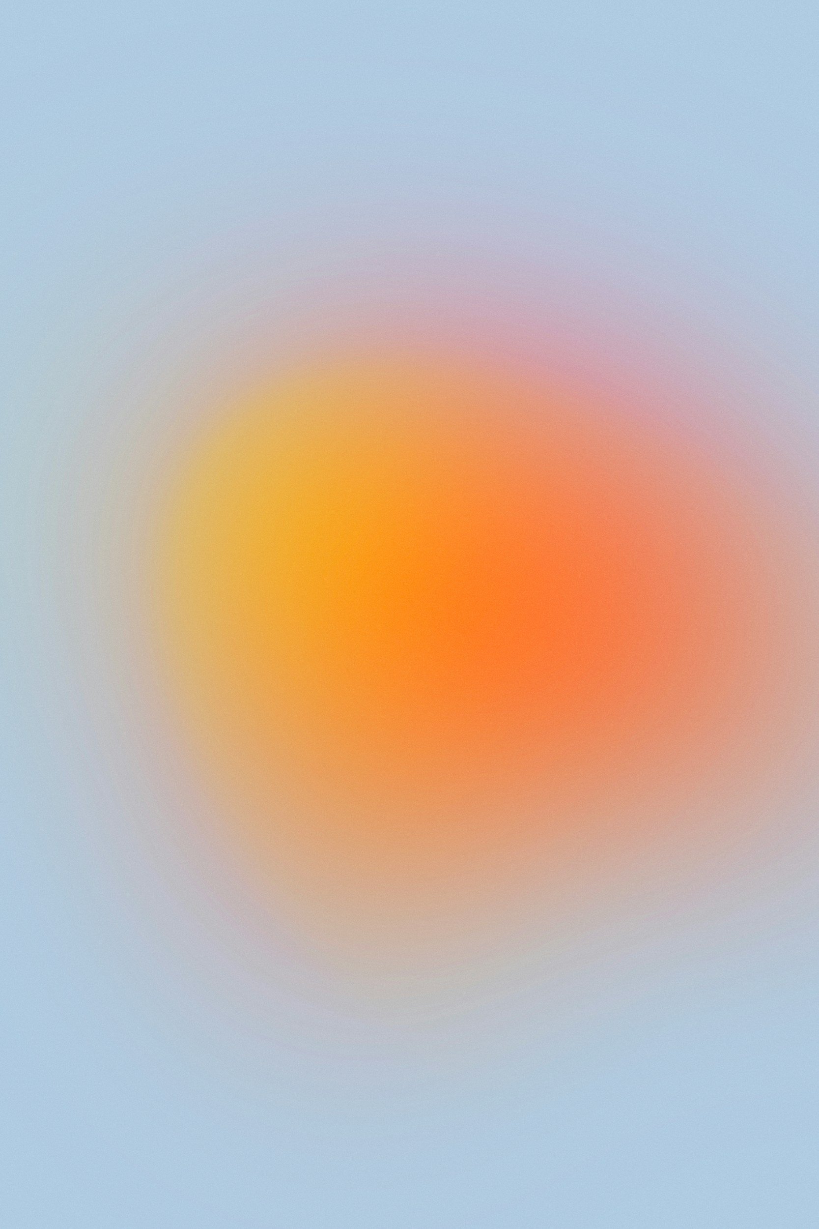 Abstract blurred gradient with soft pastel colors, blending from light blue to peach and pink.