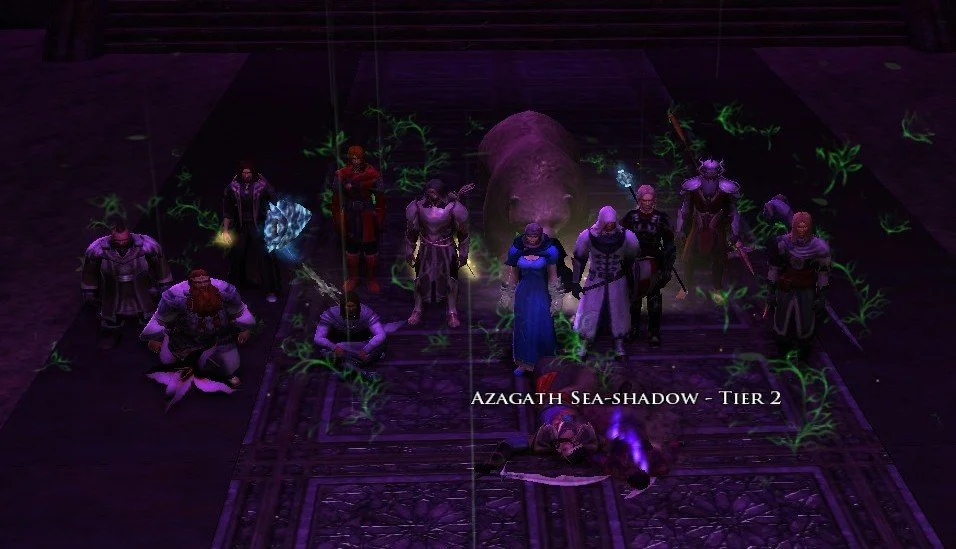 Group of fantasy characters standing around a large rock inside a dark room, with glowing green plant patterns on the floor and a glowing purple aura nearby. Text overlay says 'Azagath Sea-shadow - Tier 2'.