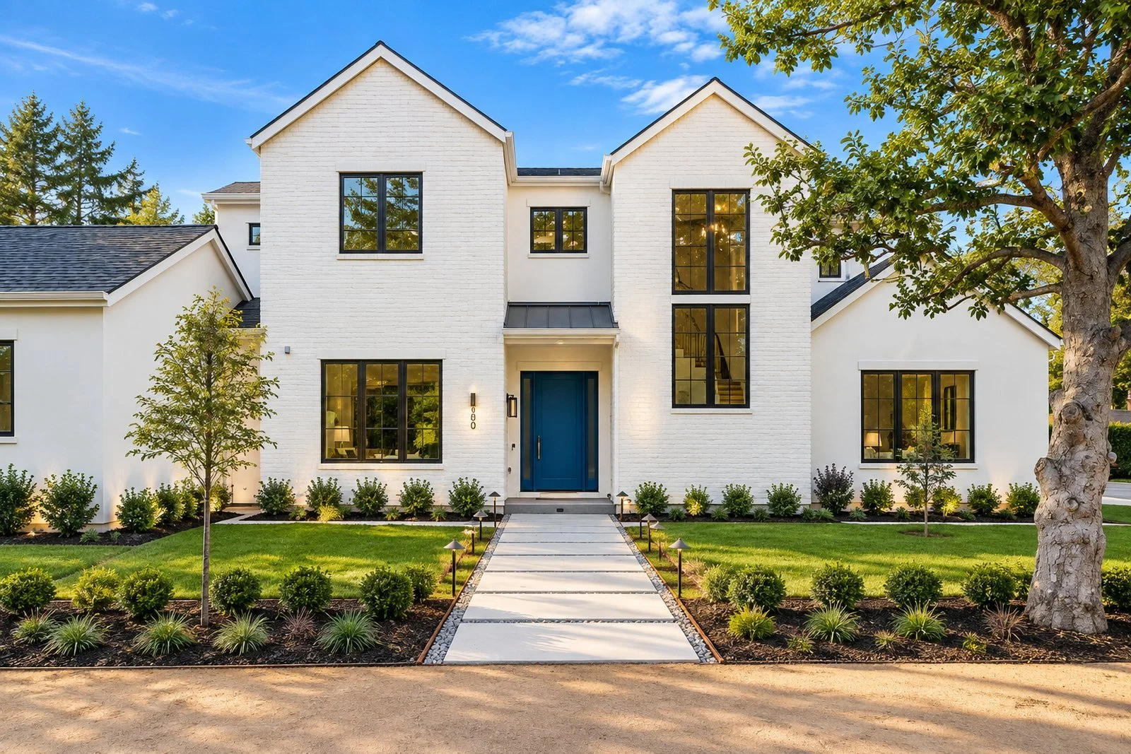 White two-story modern farmhouse with a blue front door