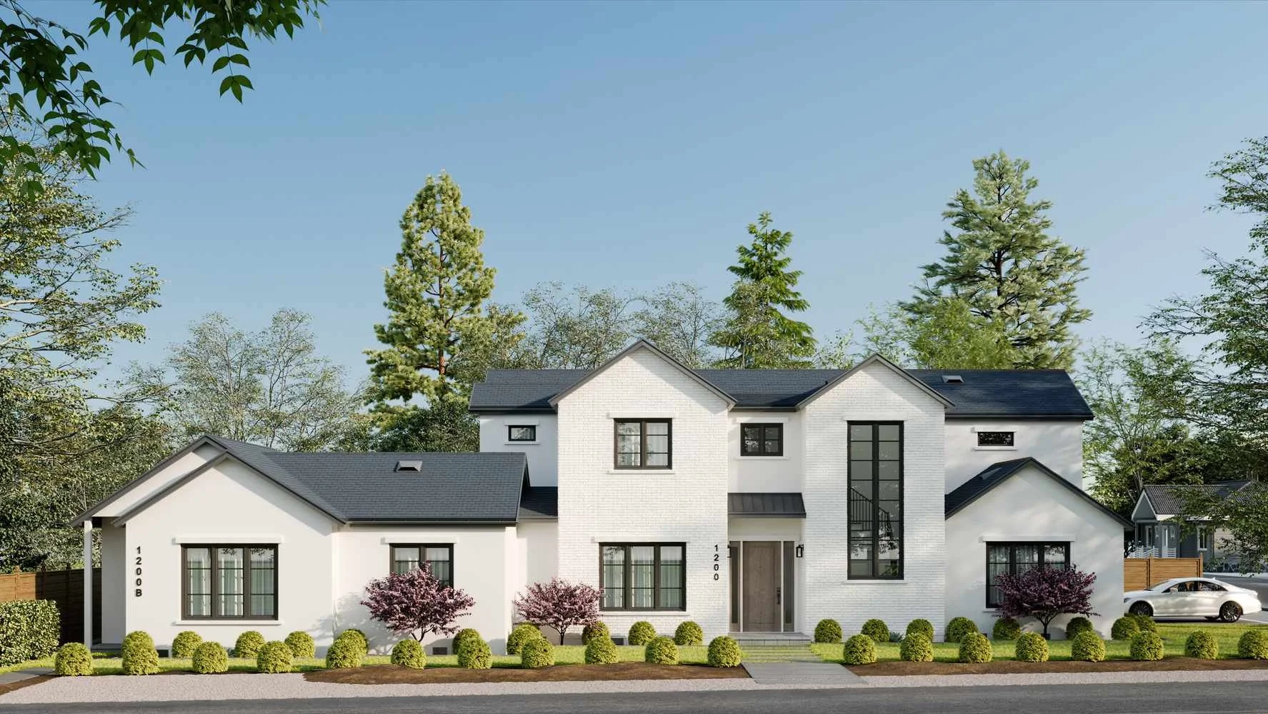 A modern white two-story house with black window frames, surrounded by green trees and bushes, with a clear blue sky overhead.