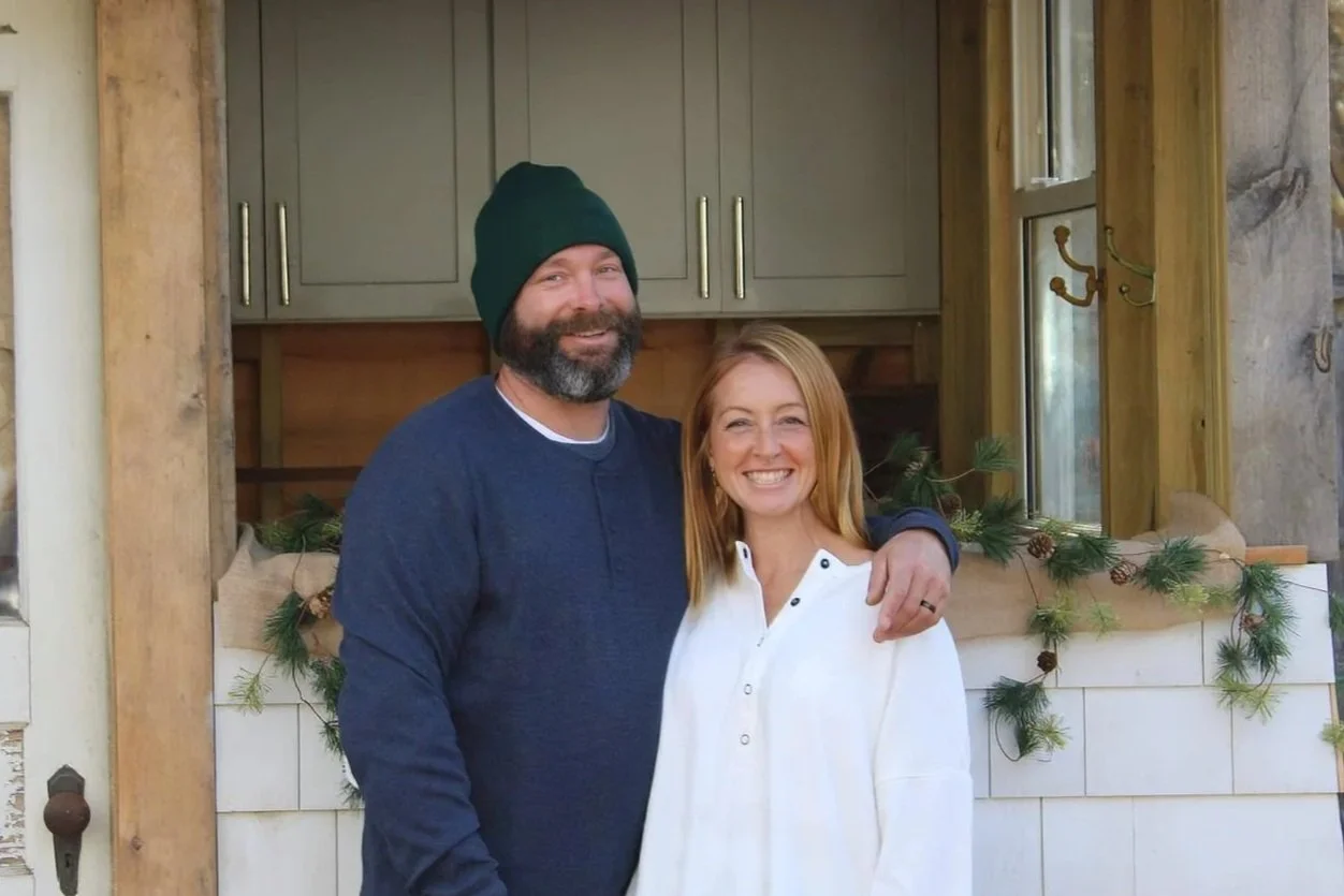 Mike Merrill and wife Amy Merrill stand in front of their farm store, Soreil. look proud and happy.