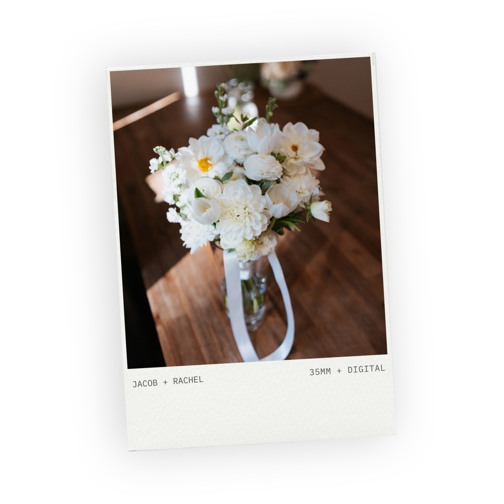 Bridal bouquet of white flowers in a vase on a wooden table