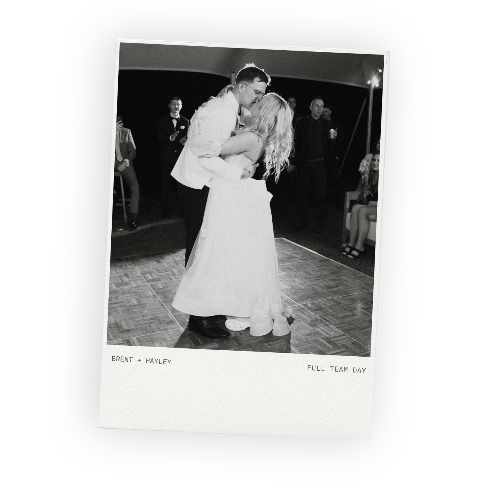 Black and white photo of bride and groom kissing on the dance floor