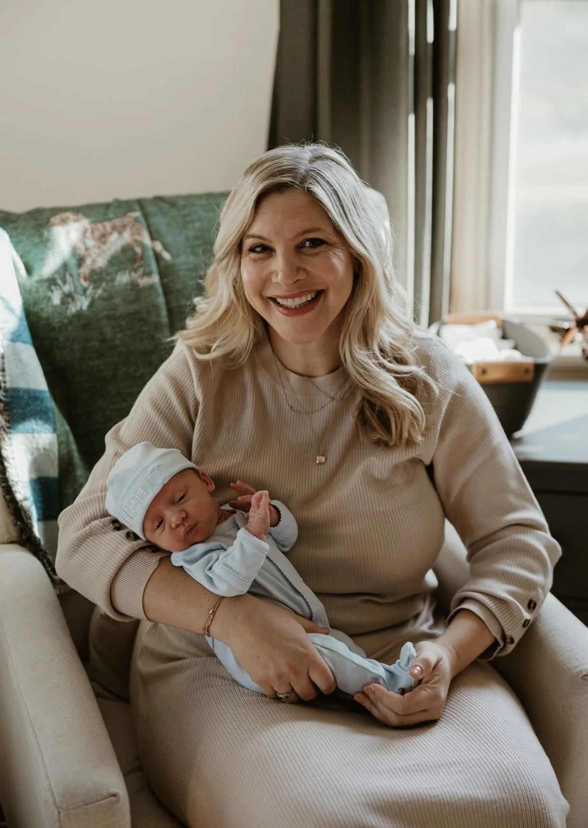 Katie holding her newborn baby at home.