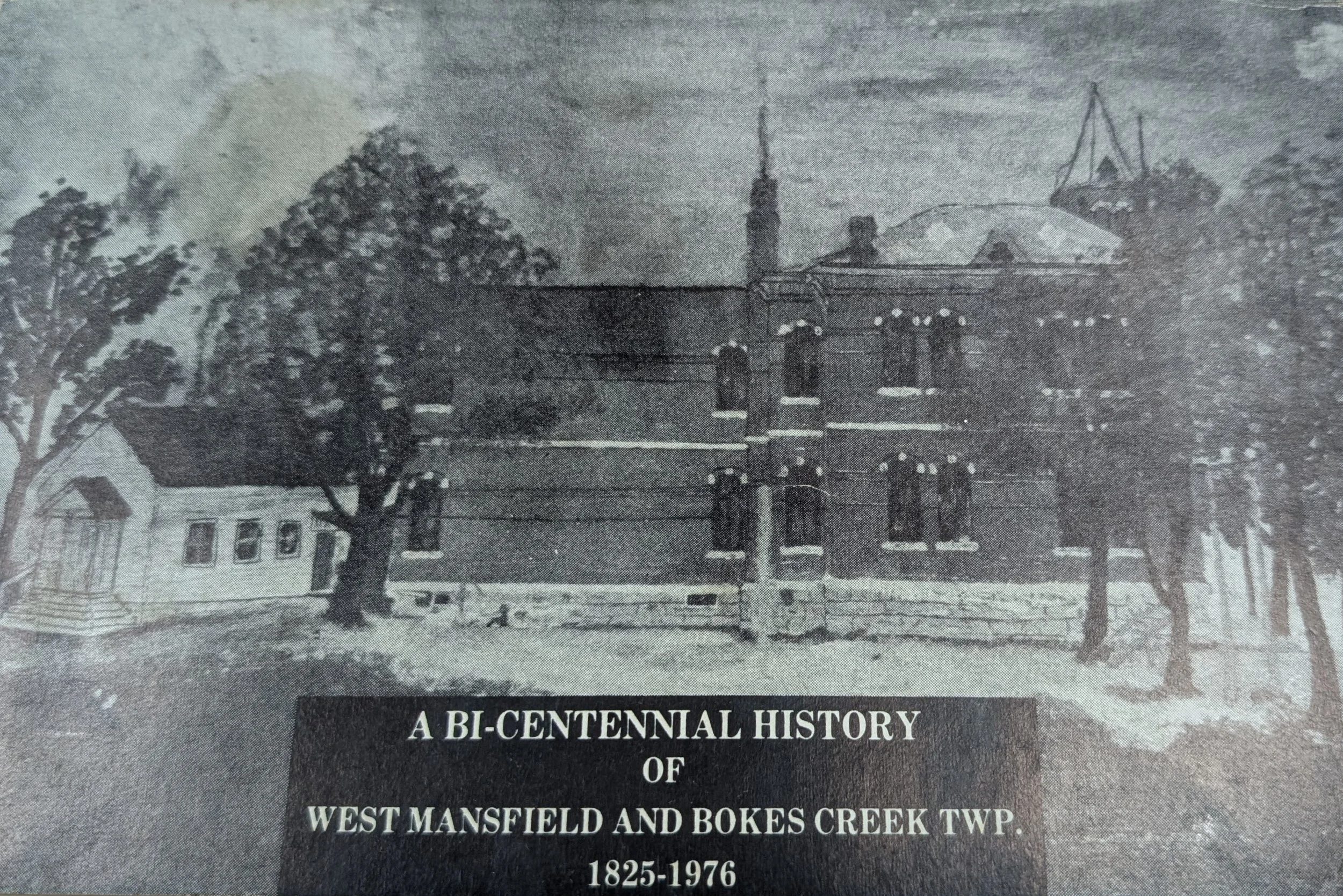 A historical black and white photograph of Bokes Creek Twin Towers, part of a bi-centennial history display of West Mansfield and Bokes Creek Township, dated 1825-1976. The image shows two towers, trees, a house, and utility poles.