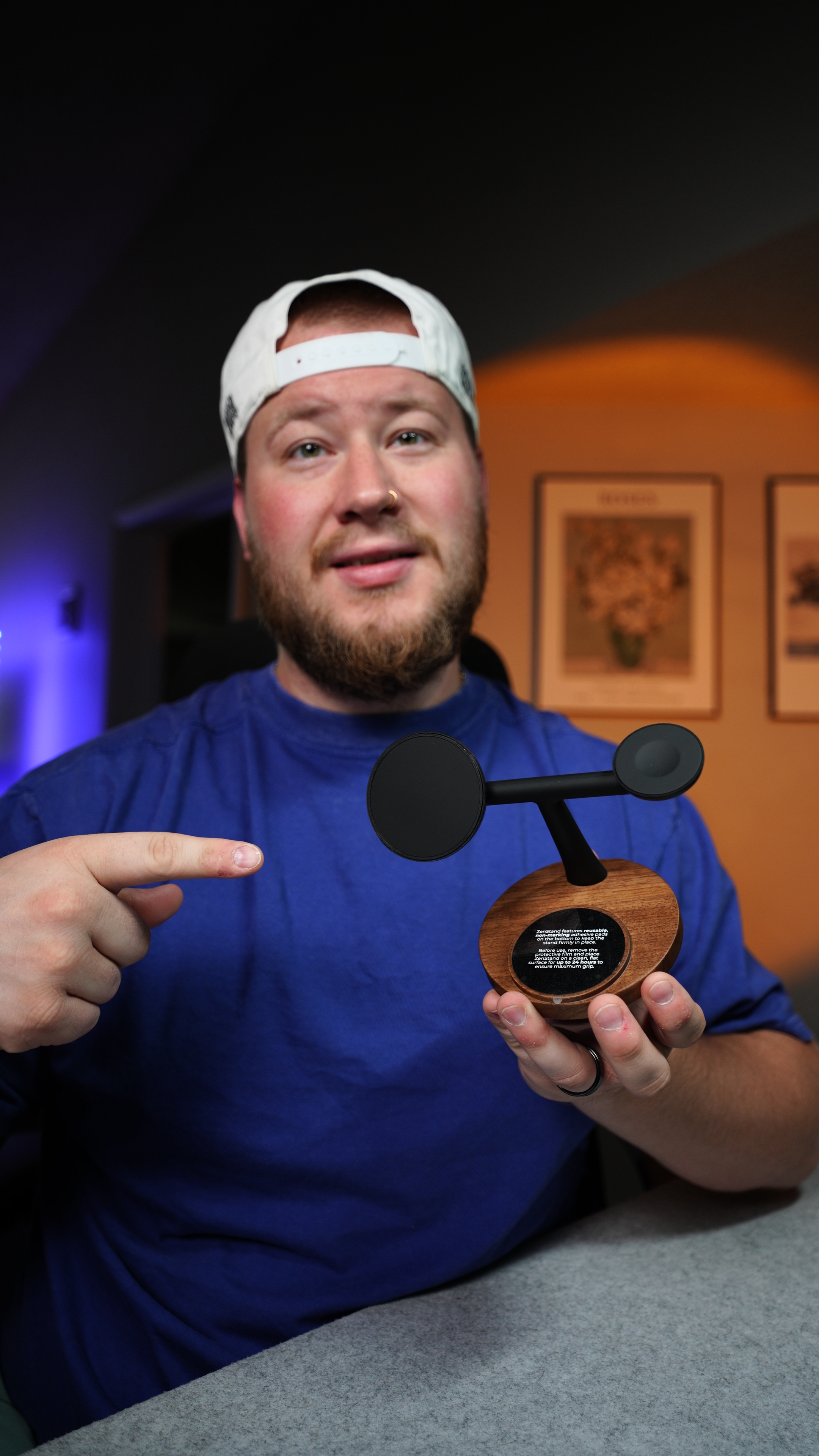 Brad holding a tech product while creating content in a home setting