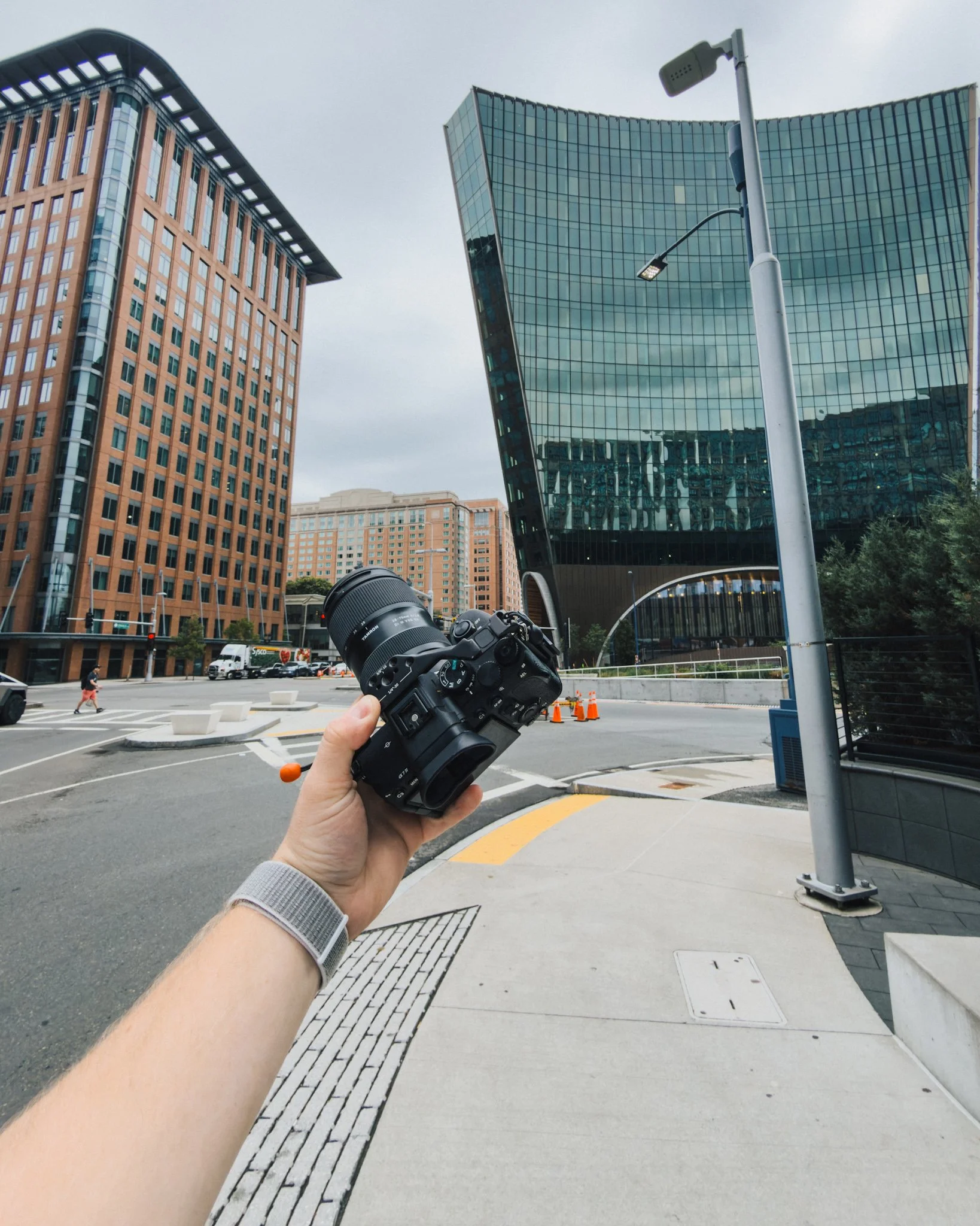 UGC creator Brad holding a camera on a city street in downtown Boston