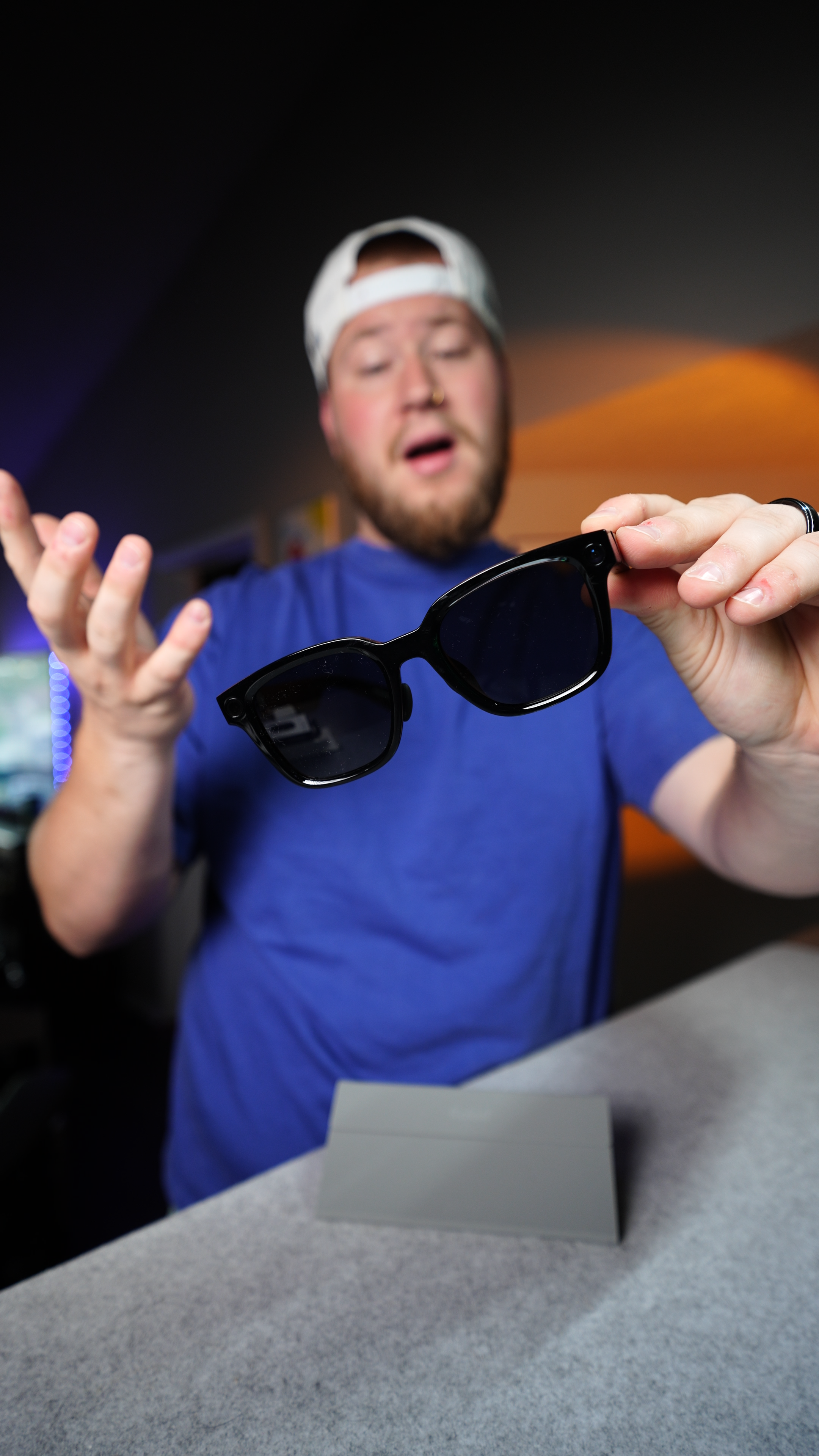 Brad holding tech AI sunglasses while creating product content