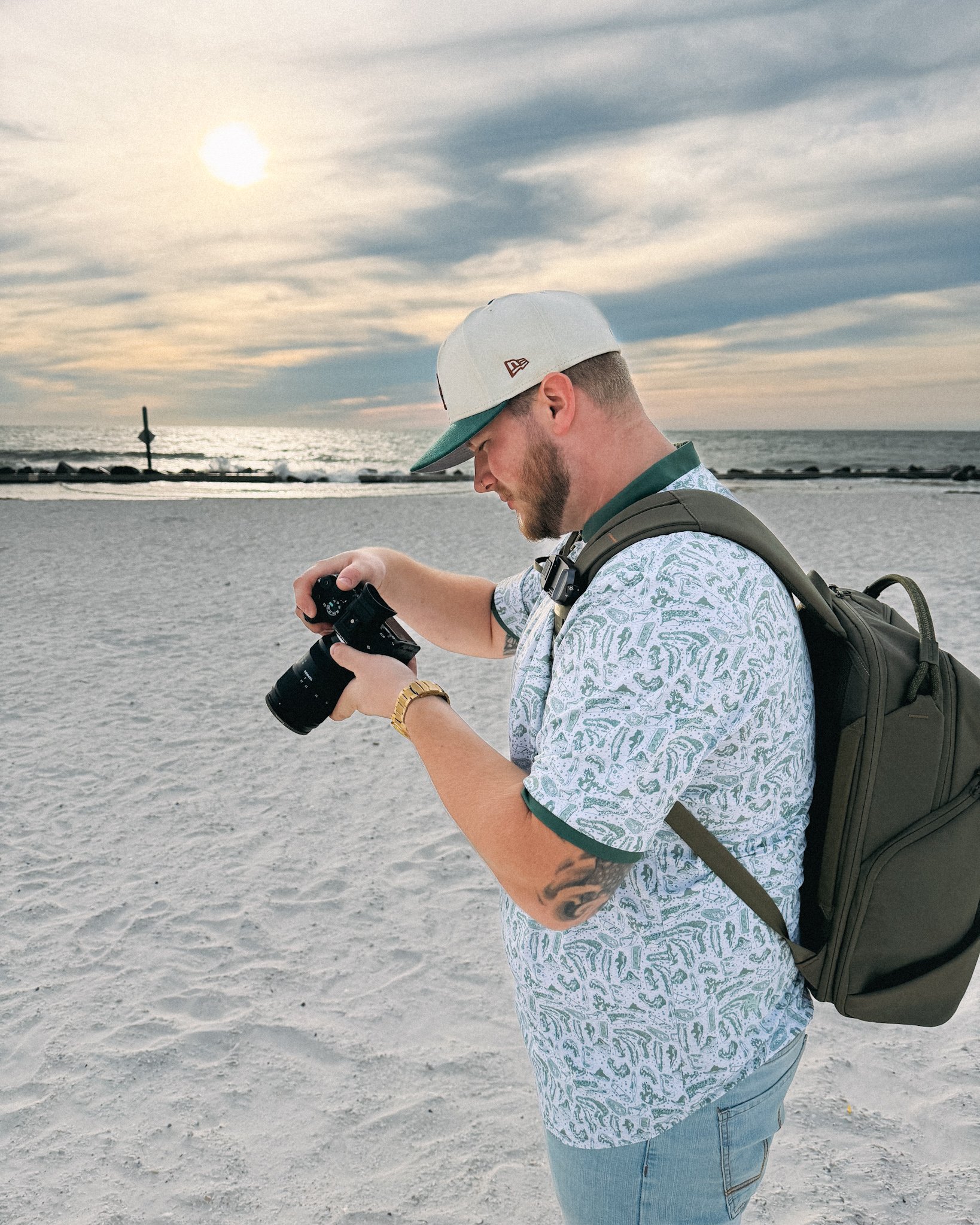 Brad holding a camera on Honeymoon Island Beach in Clearwater, Florida