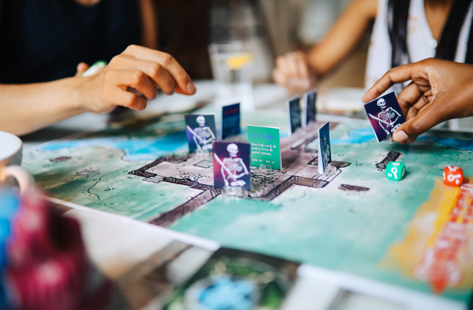 hands playing a board game