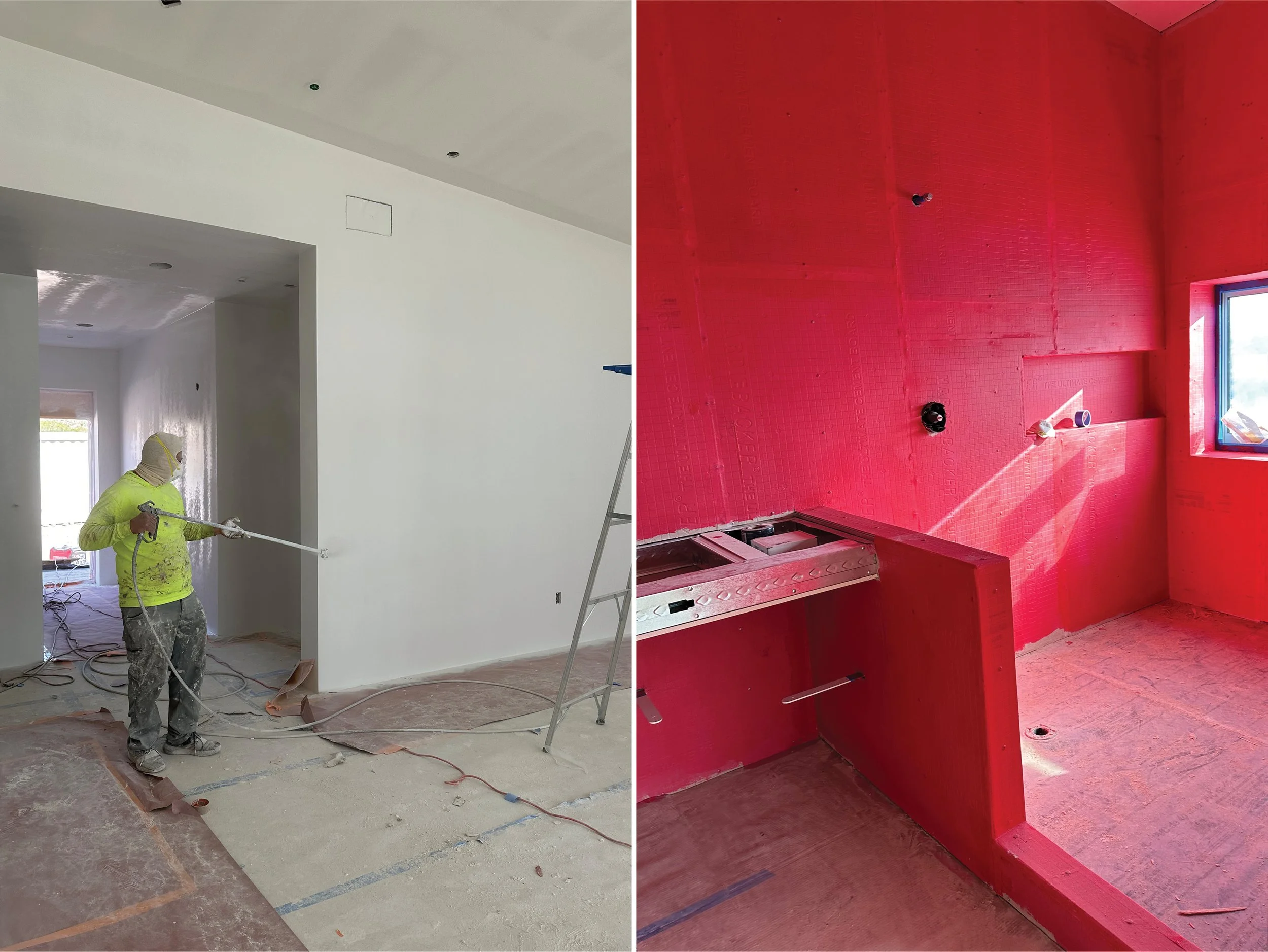 Interior construction at Panorama House showing a worker finishing drywall and a bathroom shower and bathtub area coated in red waterproofing membrane before tile installation.