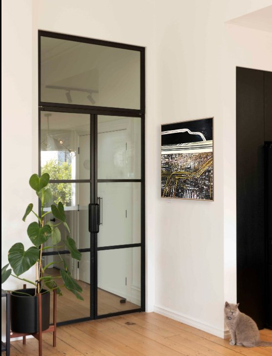 Large glass doors in a modern room with a Robert Ellis painting on the adjoining wall