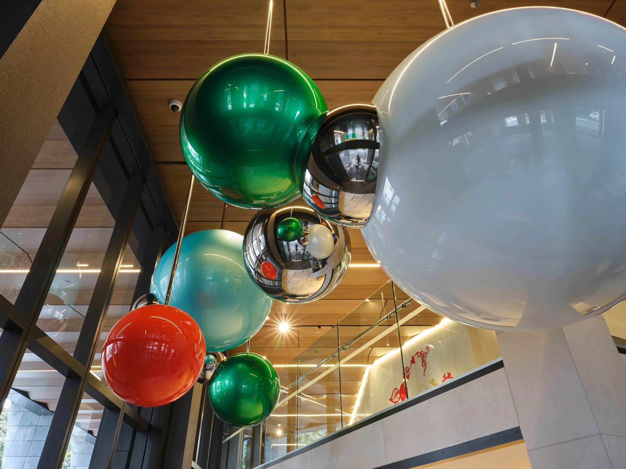 Upward shot of Seung Youl Oh large orbs/baubles suspended from the ceiling at Cordis Hotel