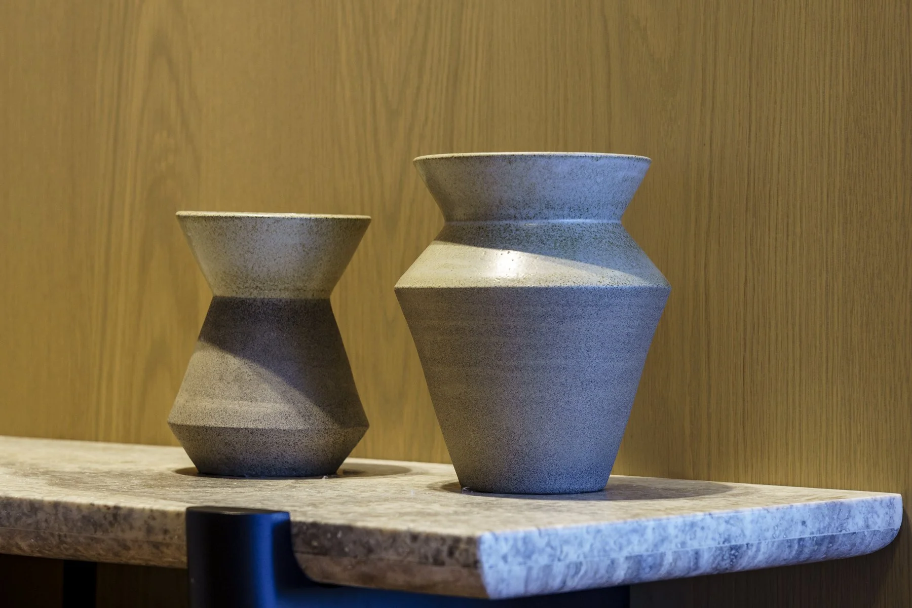 Close up of two Thea Ceramics works on stone shelf