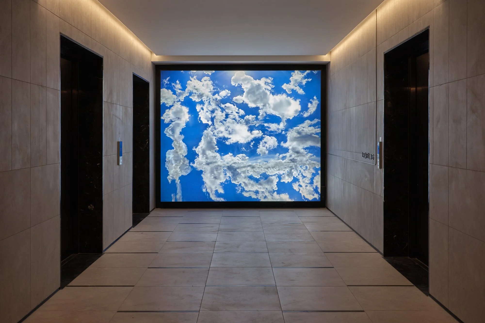 Jae Hoon Lee light box work of clouds in a hotel elevator lobby. 