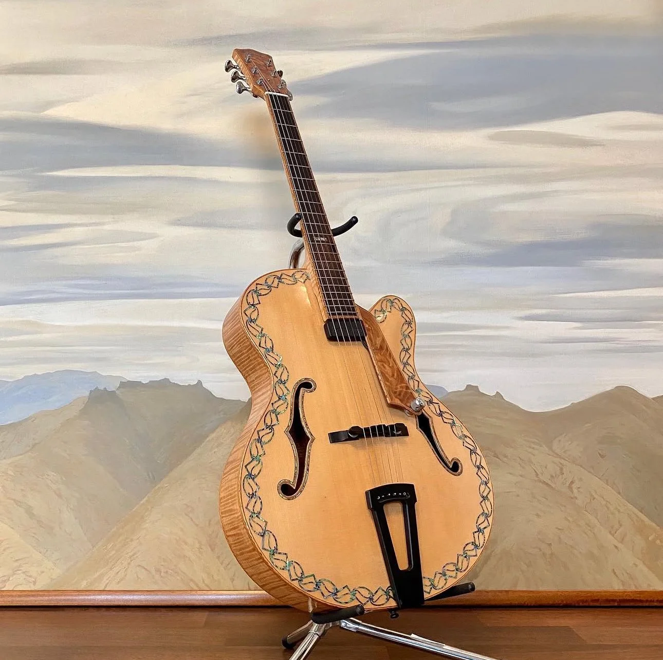 Michael Parekowhai Guitar on a stand in front of a painted landscape wall