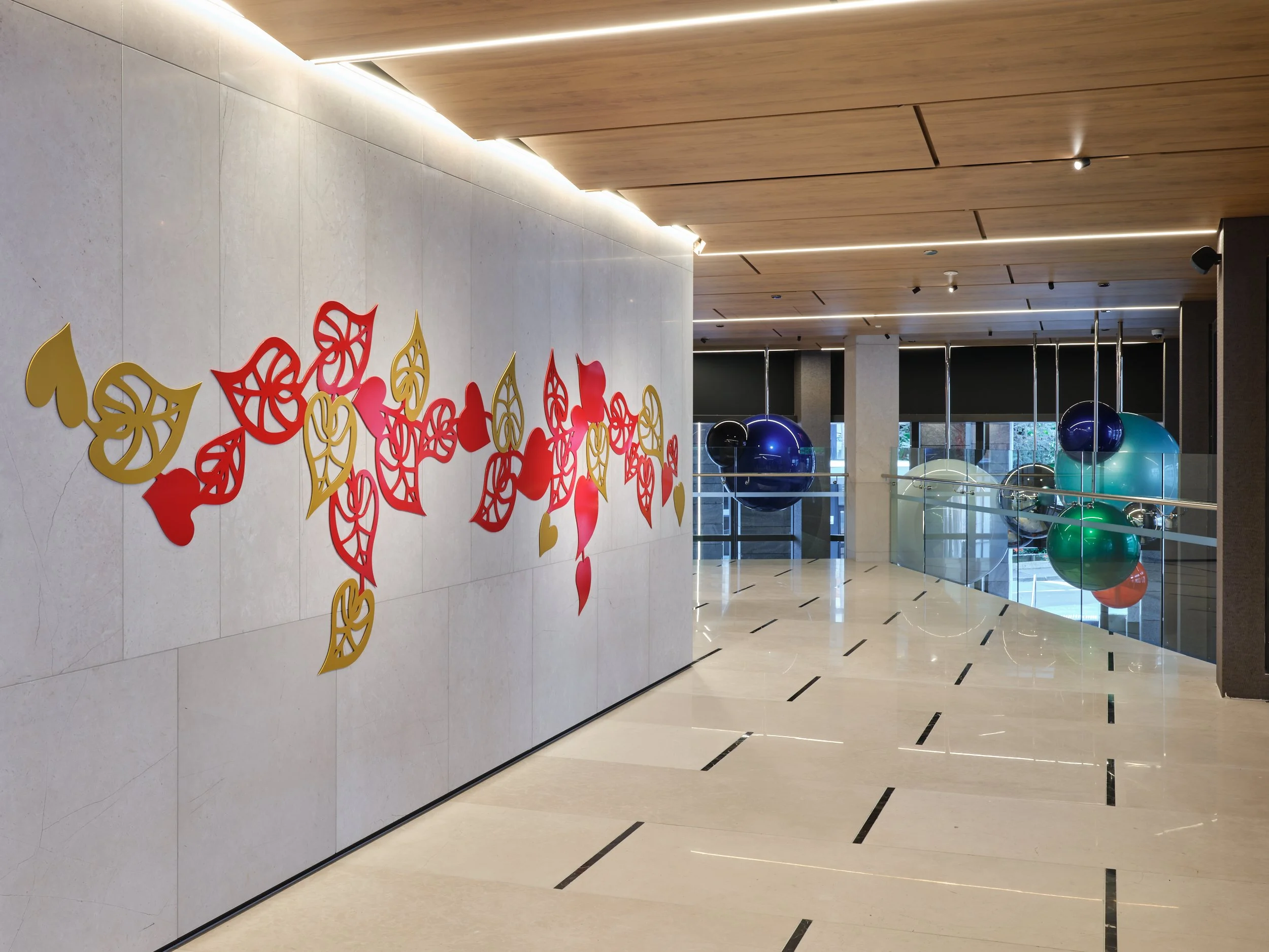 Side-on view of Lonnie Hutchinson sculptural work on a wall within Cordis Hotel