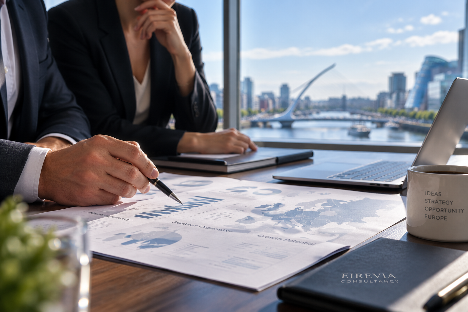 Business professionals in suits discussing documents at a conference table near a large window, with a city skyline and a river visible outside.