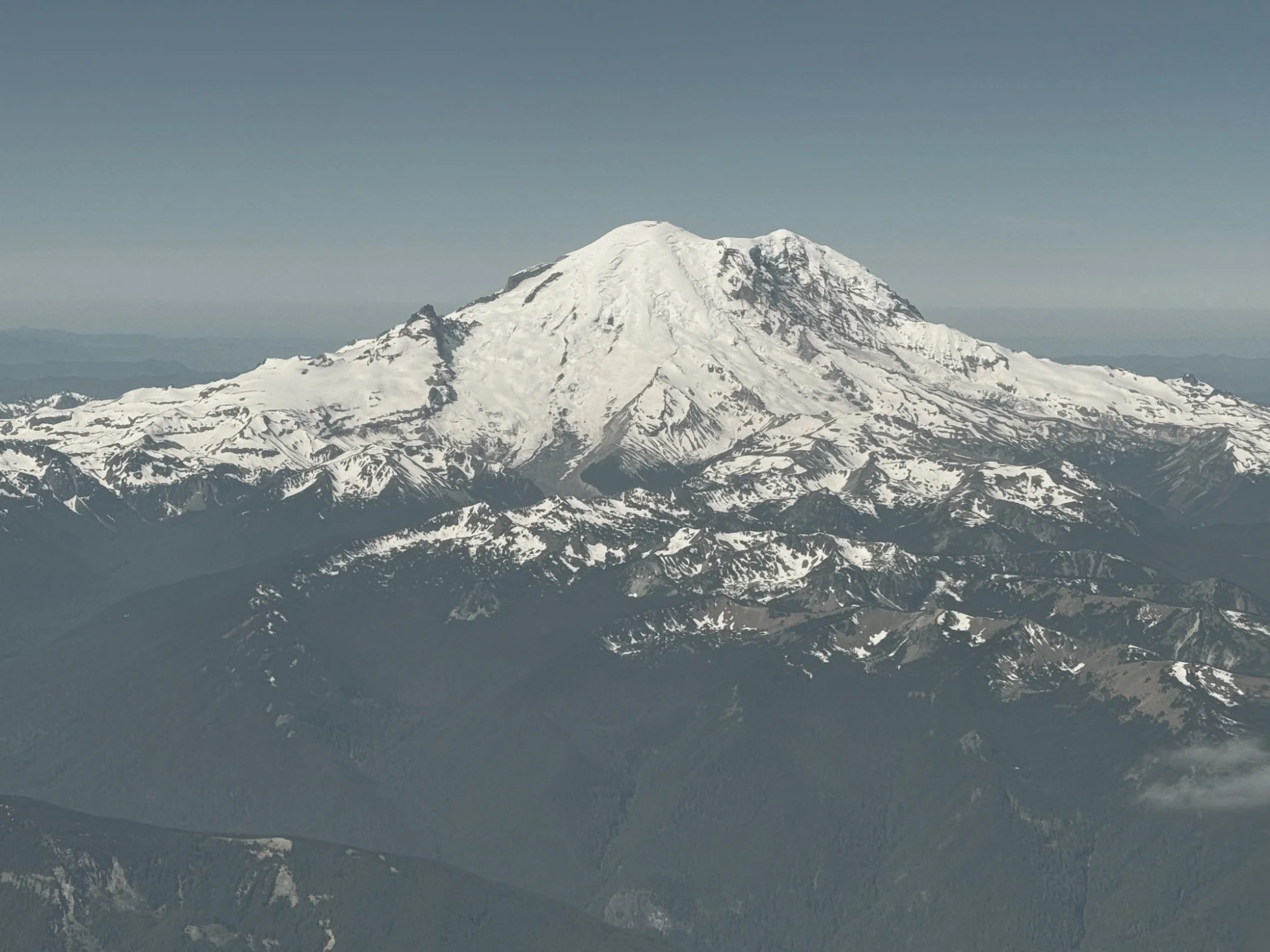 Mount Rainier covered in snow above the Cascades