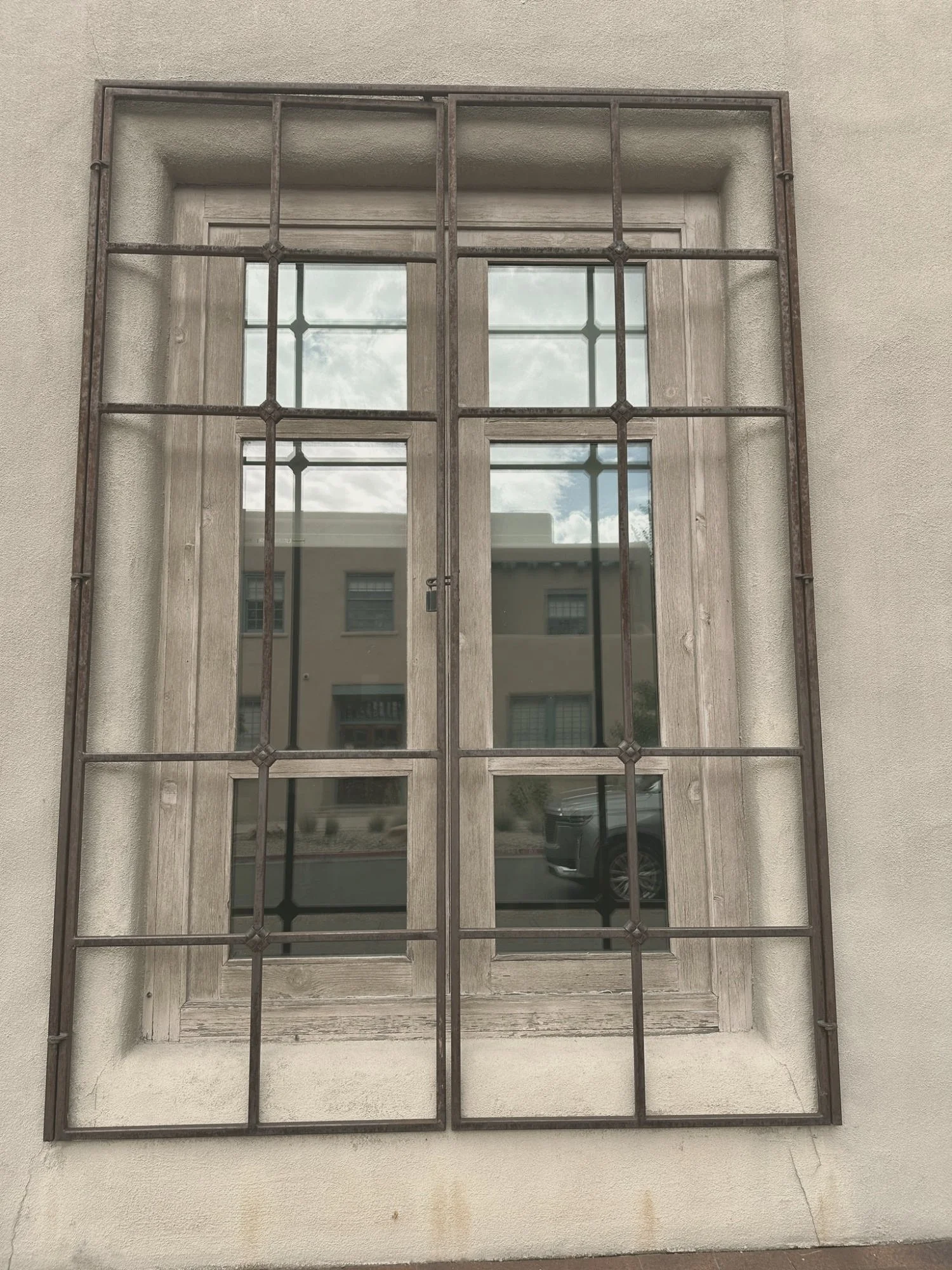 Tall window with iron panes letting in daylight