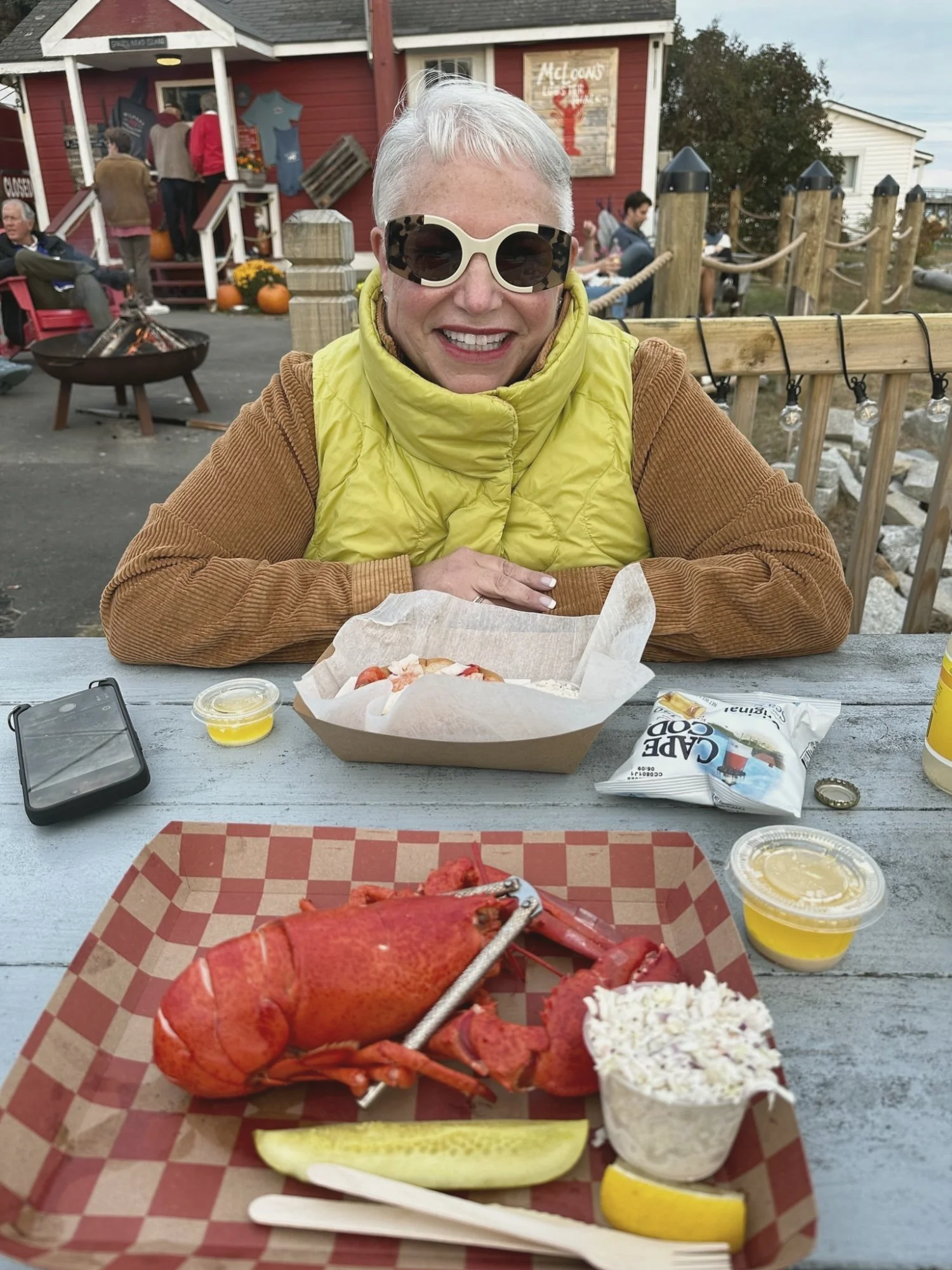 Eve at a lobster shack table by the water