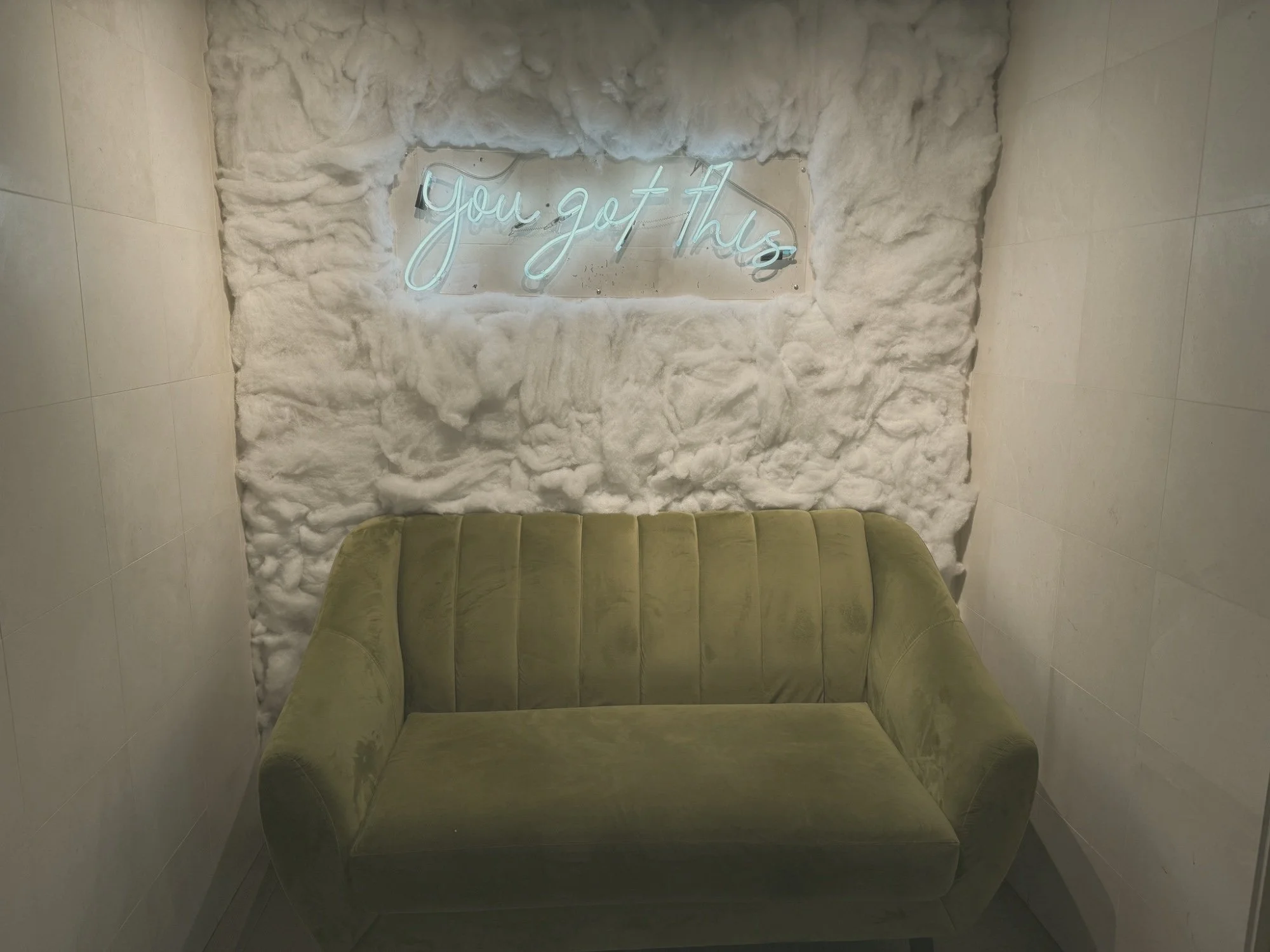 Green velvet couch in a quiet softly lit room