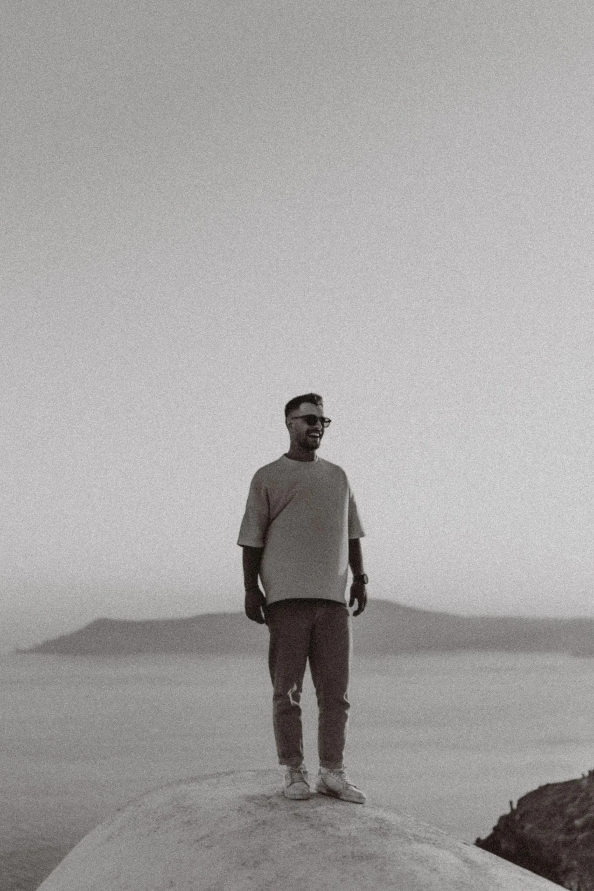 A man standing on a rooftop in Santorini