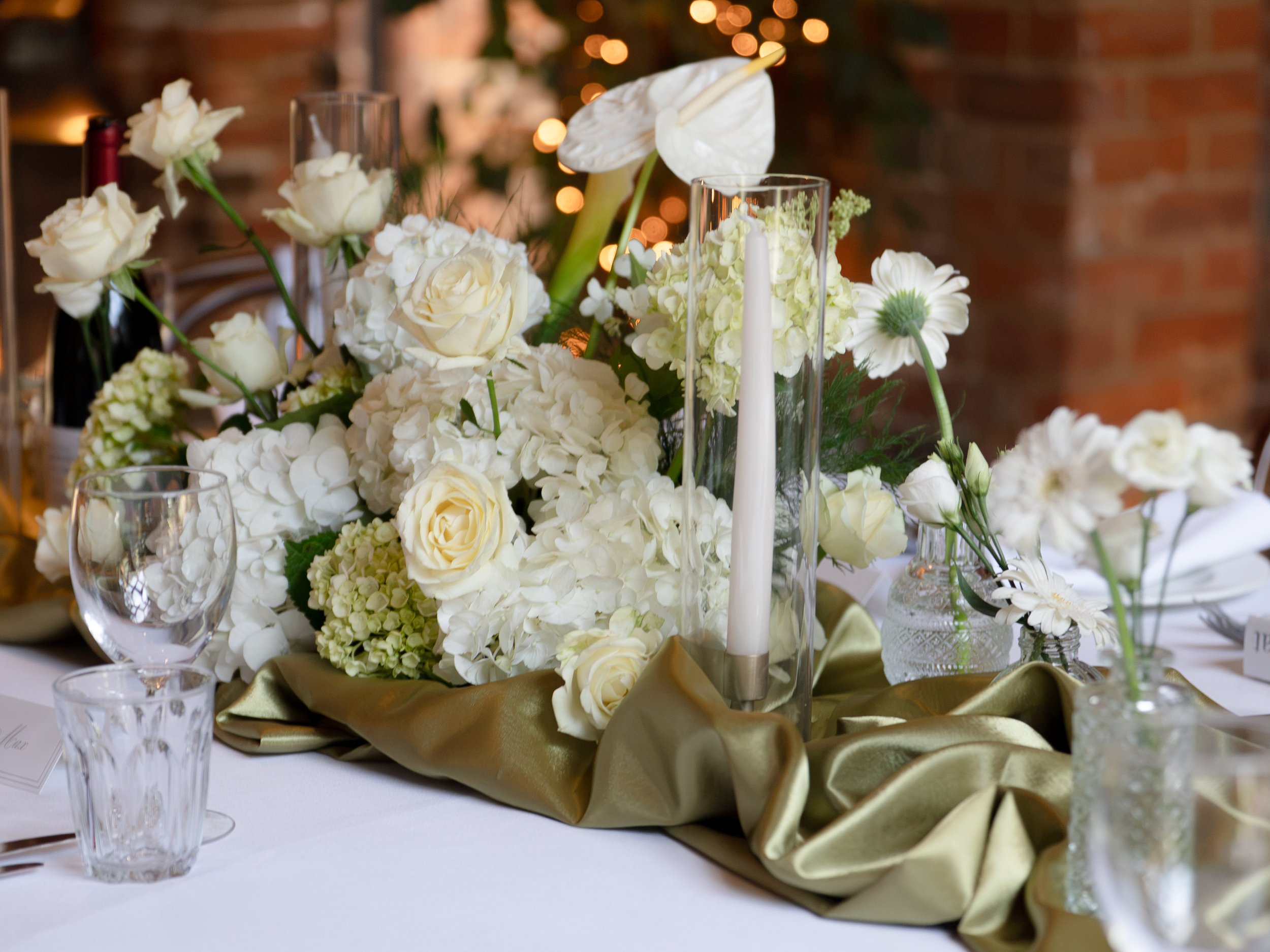 Wedding table decoration at Shustoke Barn with green and white floral theme.