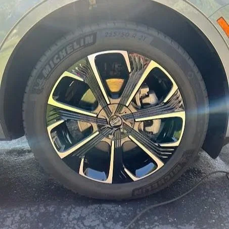 Close-up of a car wheel with a Michelin tire and a stylish black and silver alloy rim.