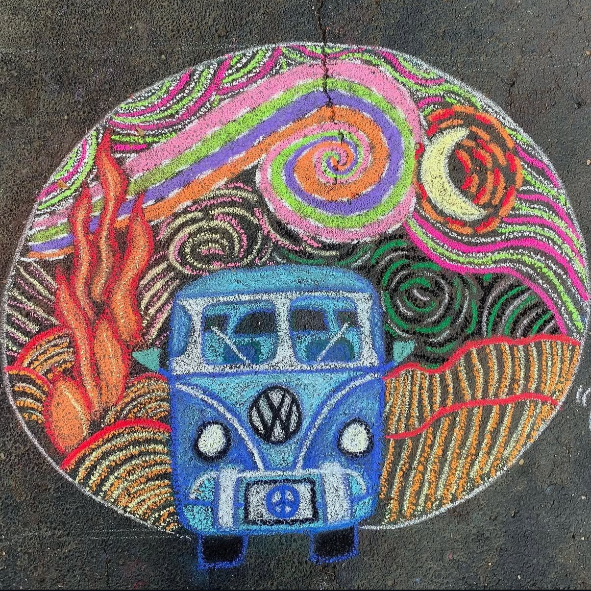 Colorful chalk art of a blue Volkswagen van surrounded by flames, abstract swirls, and patterns on pavement.