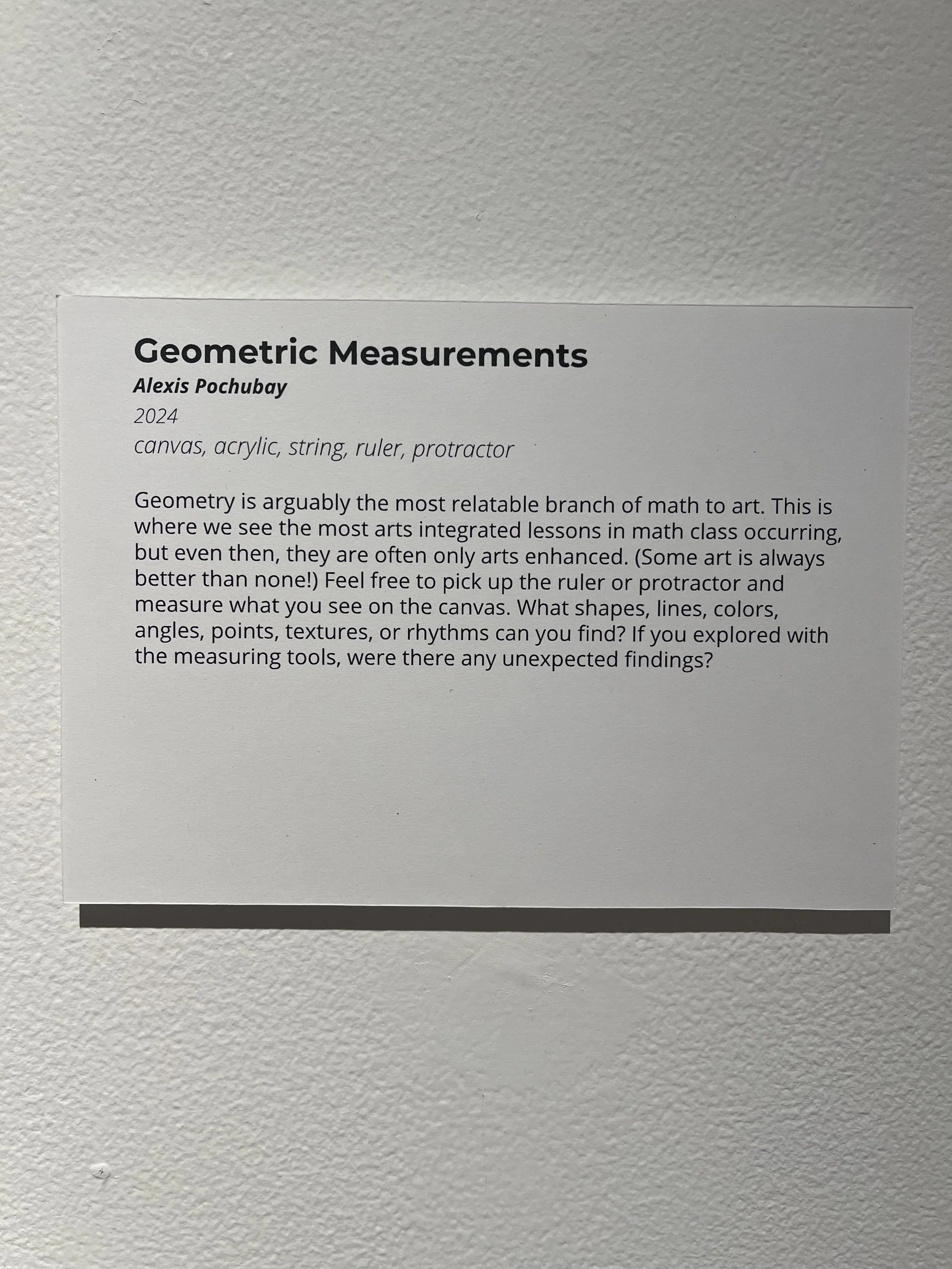 A printed informational sheet titled 'Geometric Measurements' by Alexis Pochubay, 2024, with a description about the relationship between art and math, and instructions to measure shapes, lines, colors, angles, points, textures, or rhythms on a canva