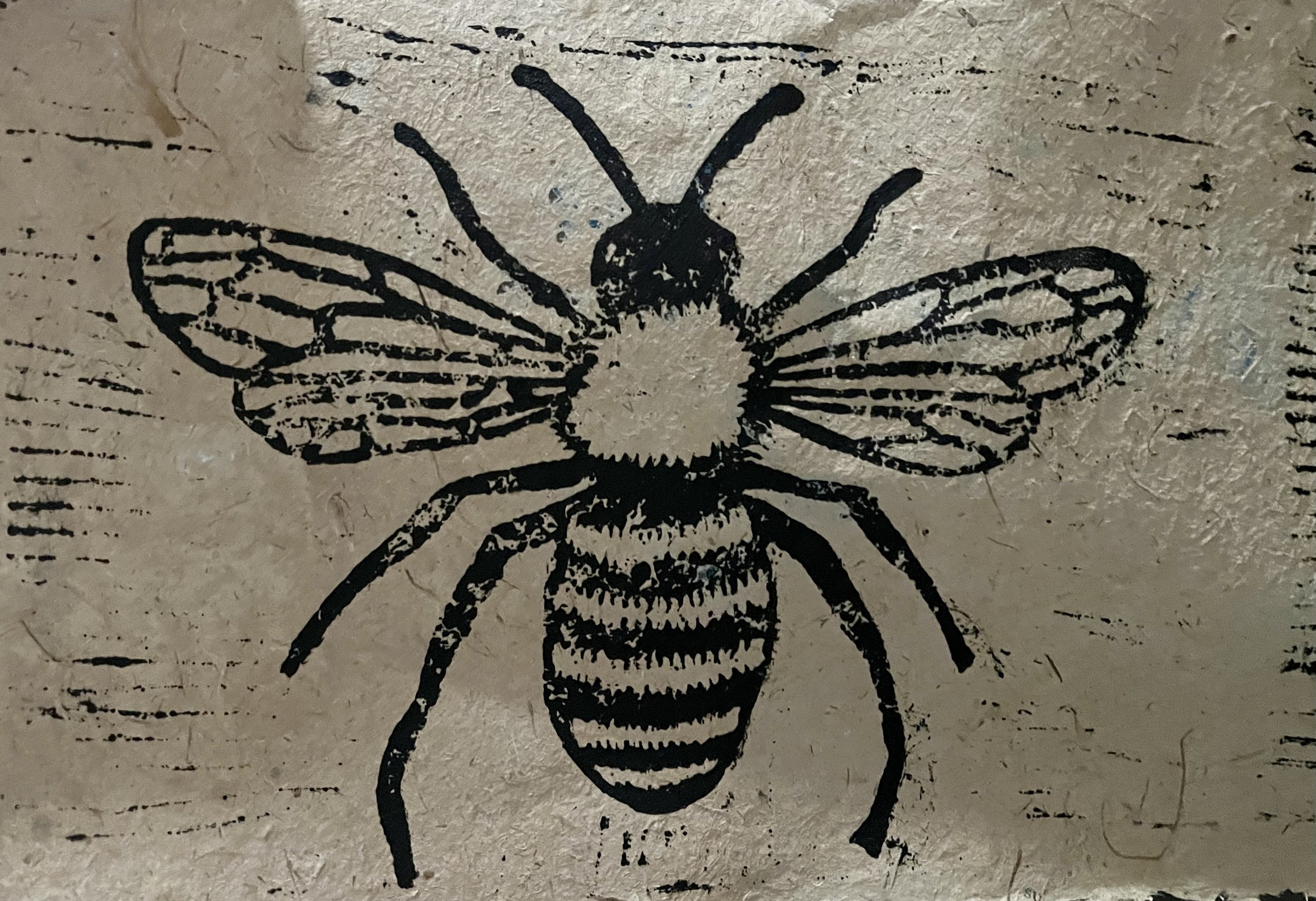 Street art graffiti of a bee on a textured wall.