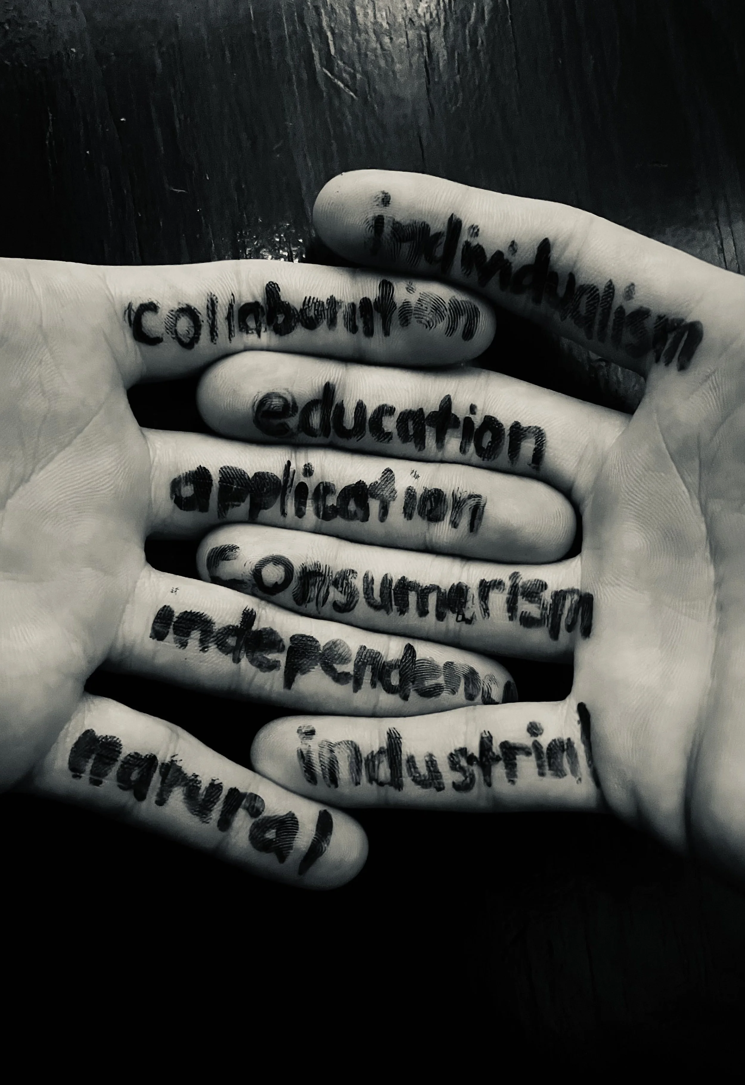 Close-up of a hand with words written on fingers via black ink, including 'collection,' 'education,' 'application,' 'consultation,' and other partially visible words.