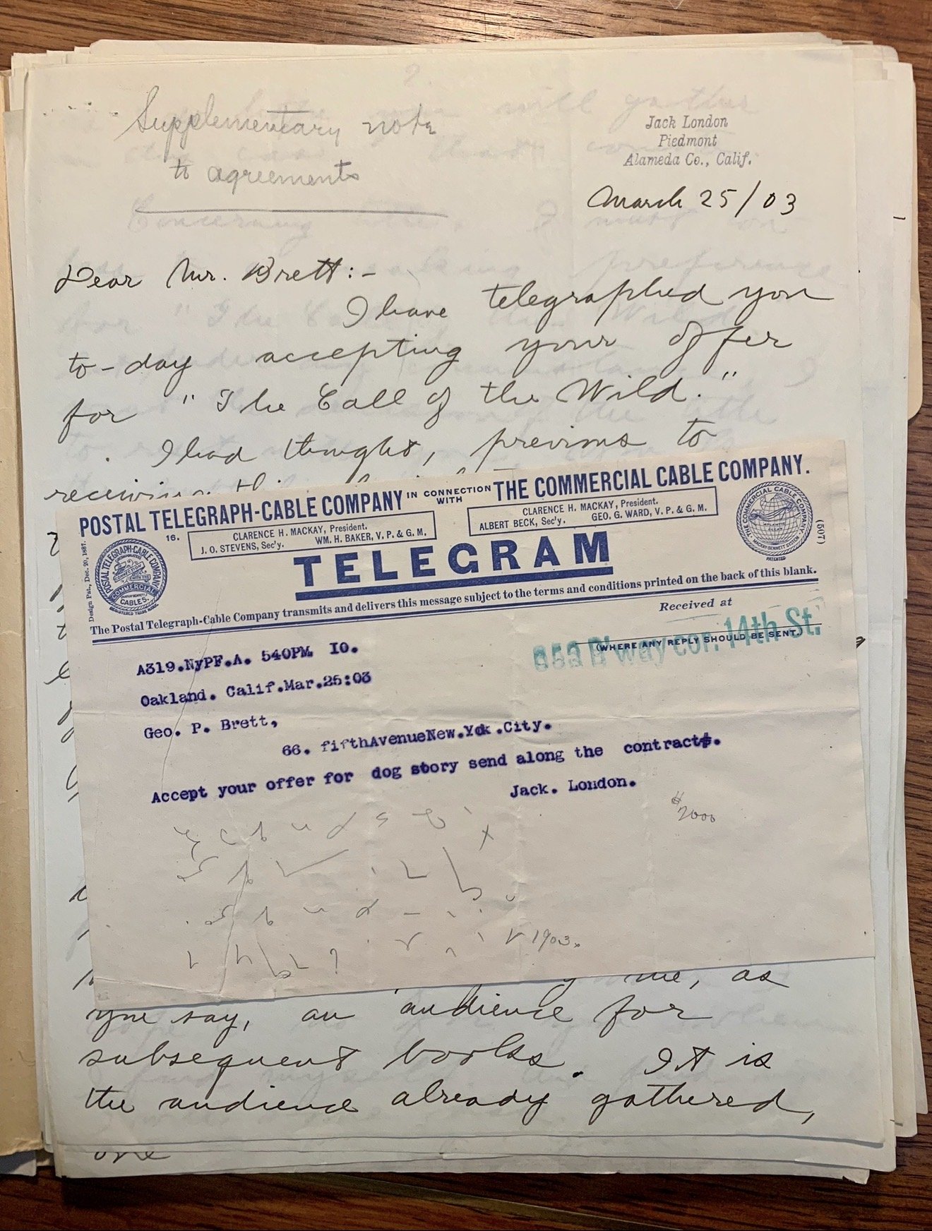 A stack of handwritten letters and telegrams on a wooden surface, with the top letter dated March 25, 1903, and a telegram from Oakland, California.