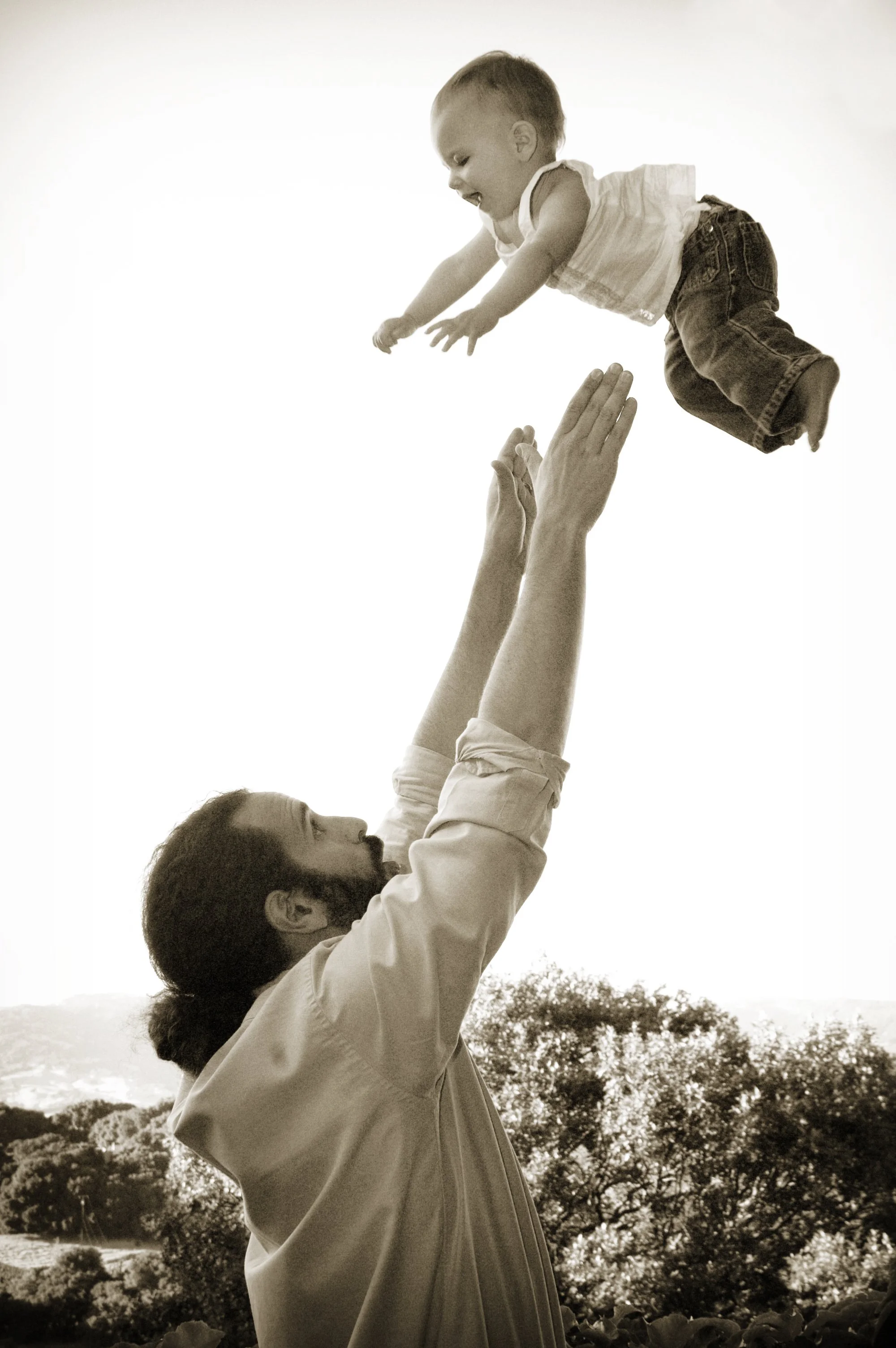 Randy, years ago, tossing his baby daughter into the air.