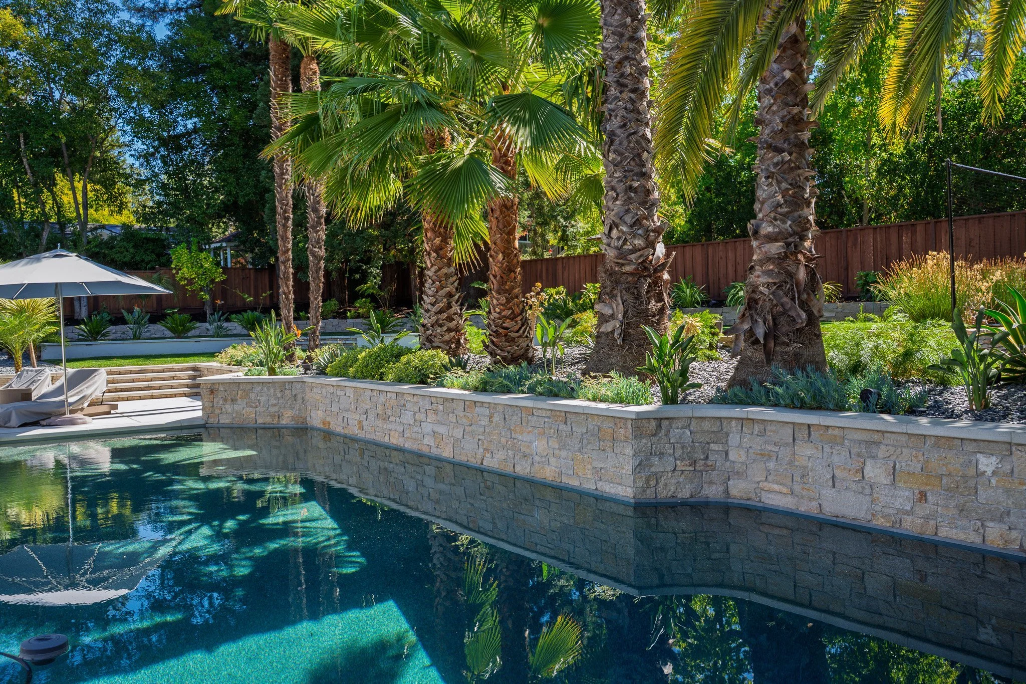 gh-pool-stone-retaining-wall-palms.jpg