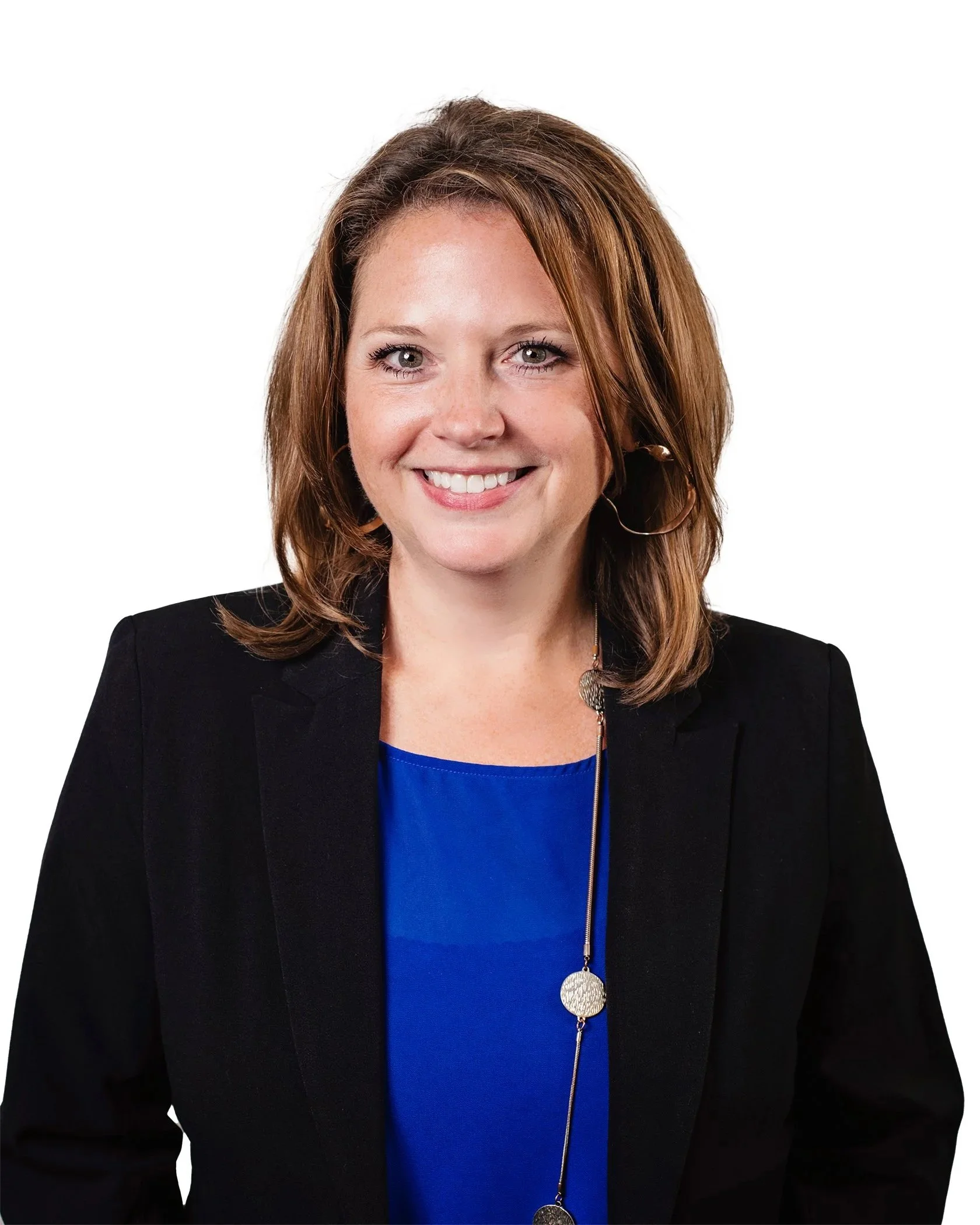 Portrait of Tracy J. Neidel with shoulder-length light brown hair, wearing a black blazer over a blue top, smiling, against a white background.