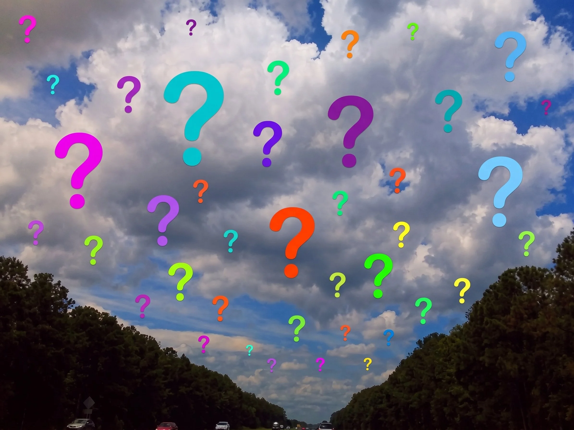 A sky filled with mostly clouds and some blue sky, over a tree-lined highway with cars, and colorful question marks overlaying the image.