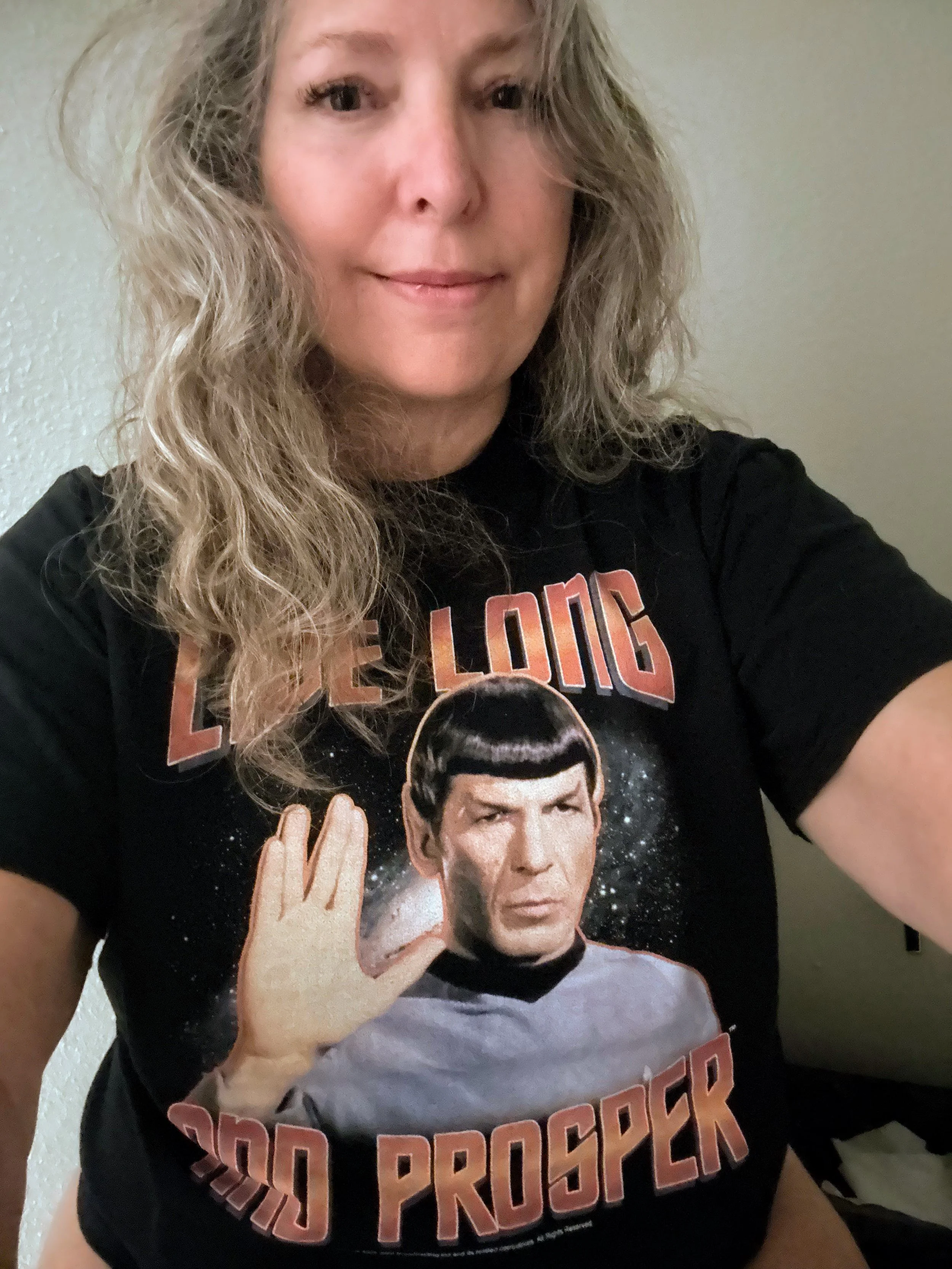 A woman with curly blonde hair wearing a black t-shirt featuring Mr. Spock from Star Trek holding his hand up in a Vulcan salute, with the words "Cold Processor" in bold orange letters.