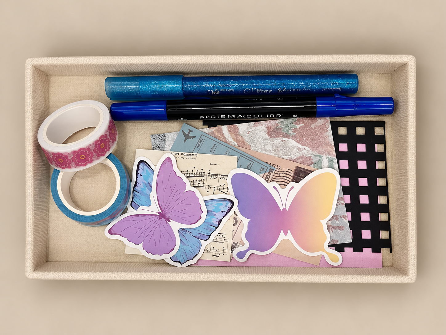 A colorful assortment of stickers, paper, washi tape, and glitter pens.