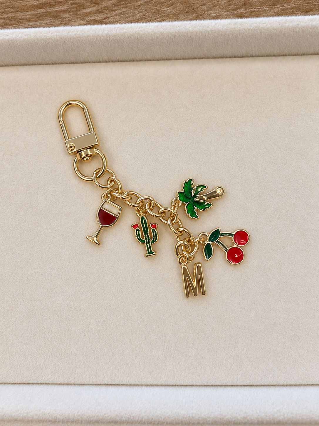 Beautiful gold keychain with colorful charm.